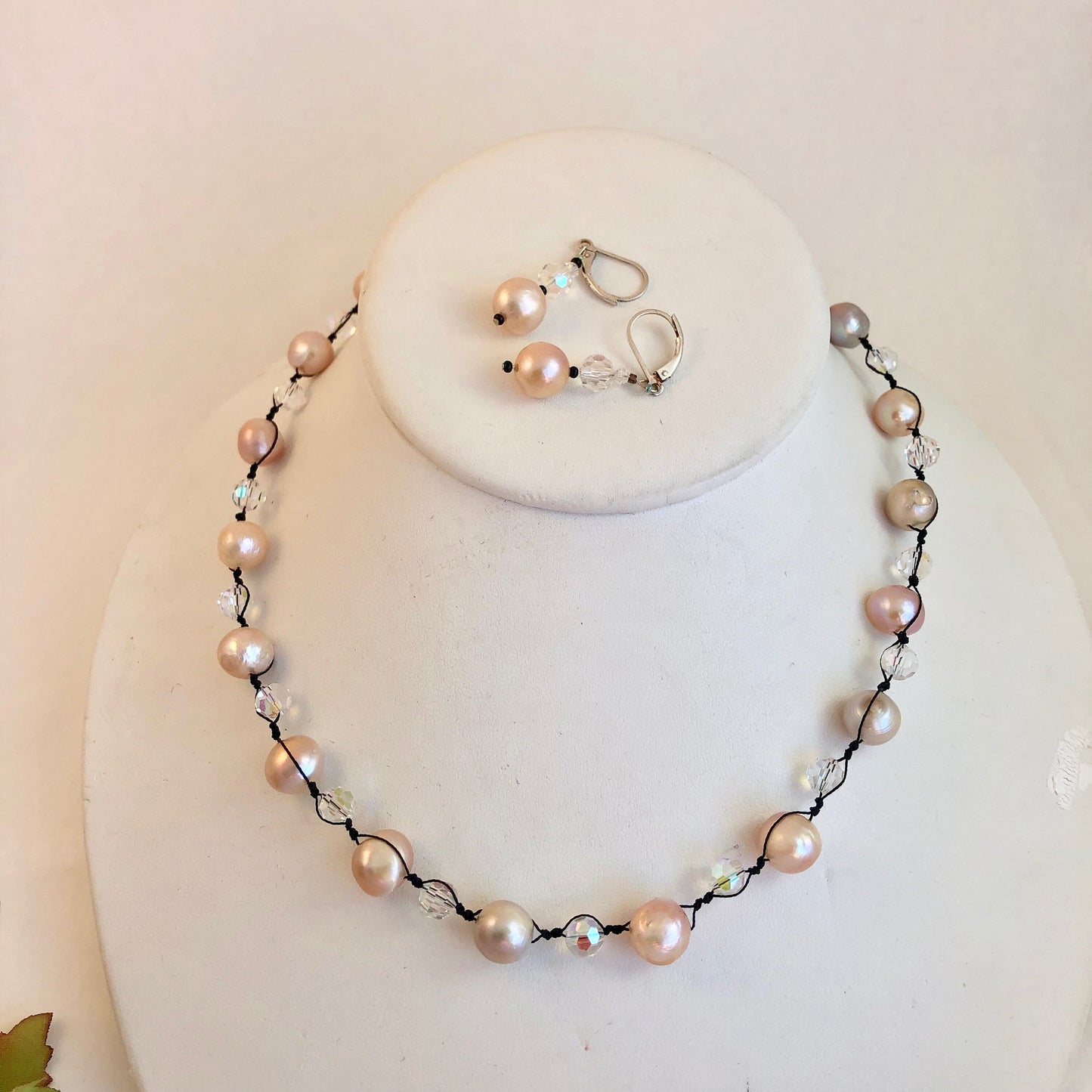 Pearls. Beautiful knotted pale pink fresh water pearl necklace. The necklace is knotted with black silk thread and accented with crystal beads.