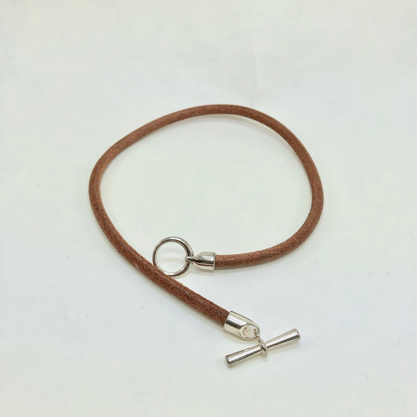 Beautiful Italian brown leather choker necklace fashioned with a center silver toggle clasp.