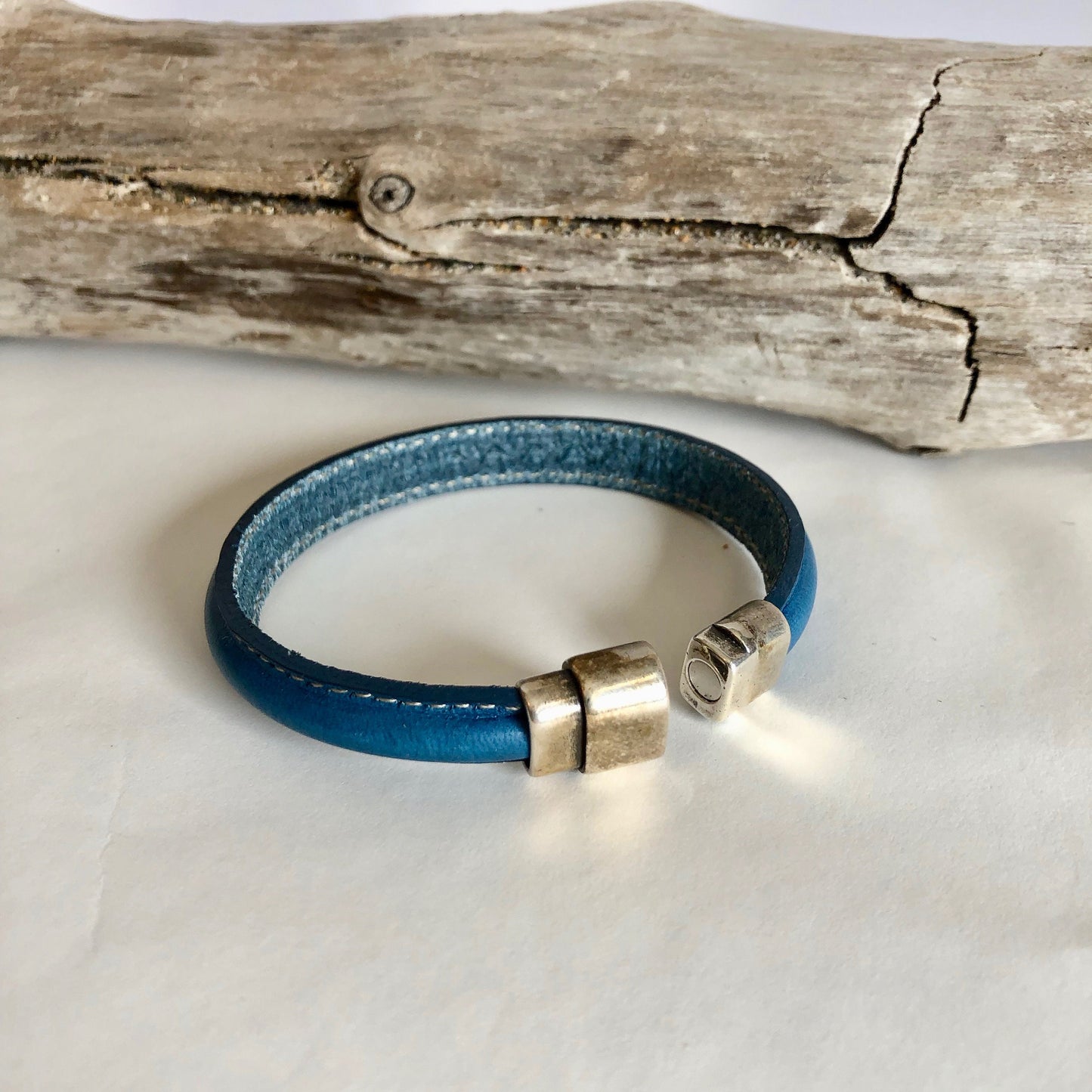 Leather bracelet, made of fine teal color Italian half- licorice leather, finished with a quality silver magnetic bullet style clasp.
