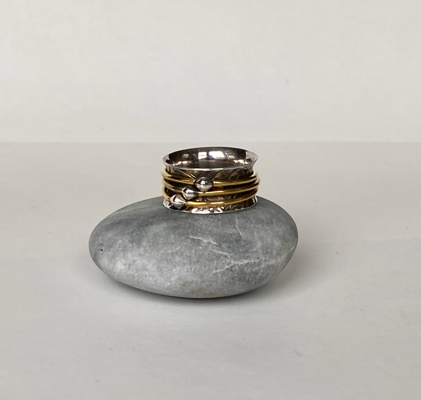 Handmade size 7 1/4 sterling silver and brass spinning ring.