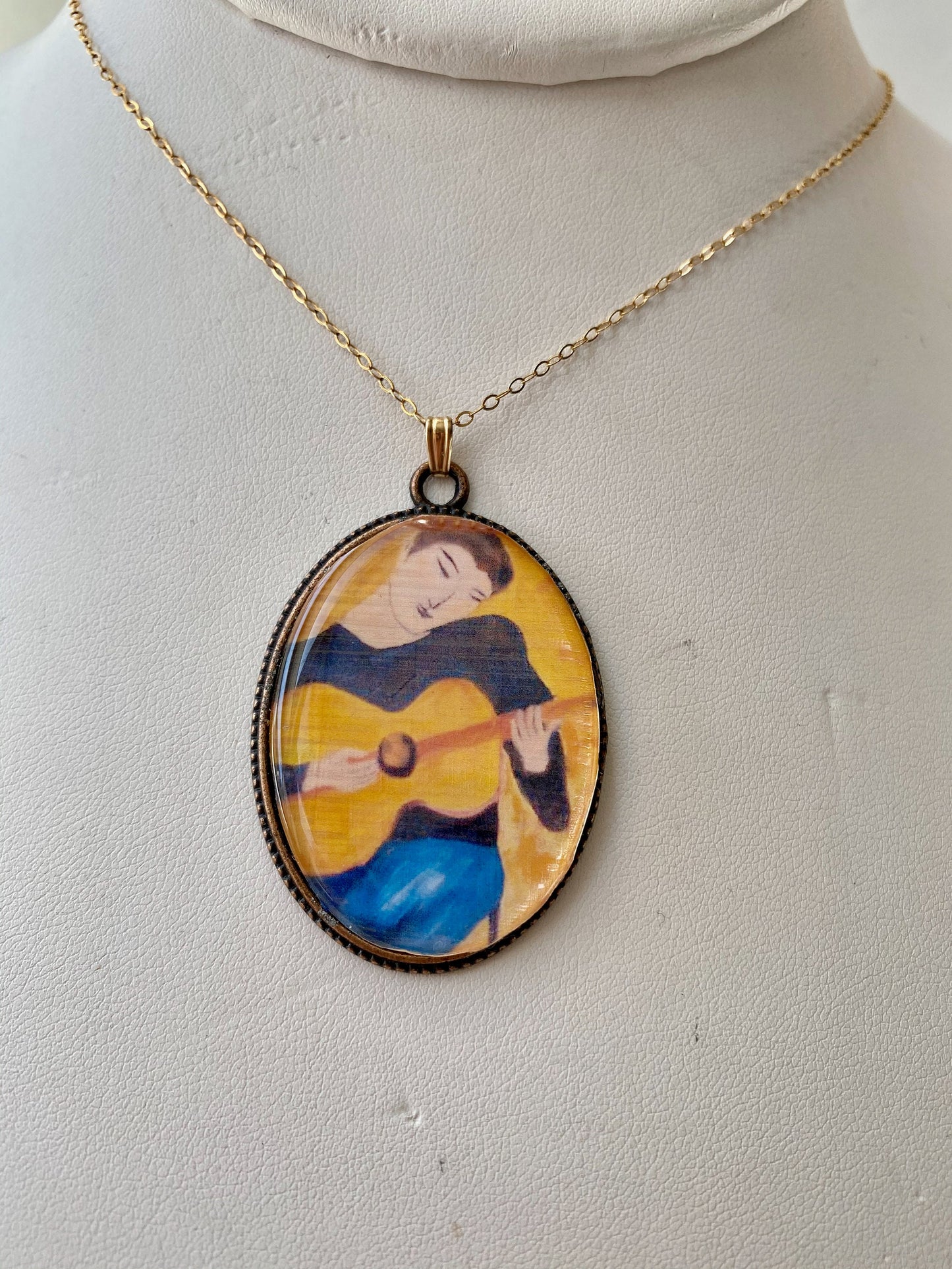 Original and beautiful hand painted guitar boy pendant. Brass frame and 14 karat gold filled chain.