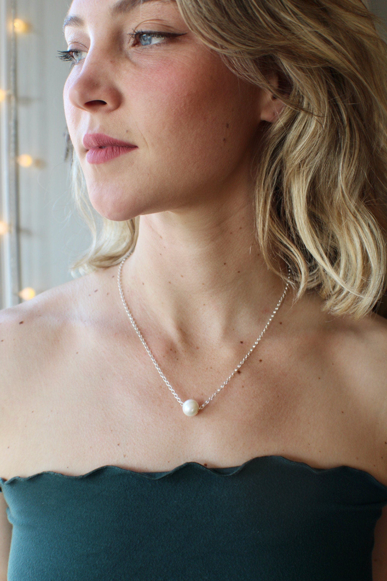 Pearls. Elegant pearl necklace. This single smooth white pearl slides freely on this lovely quality sterling silver chain.