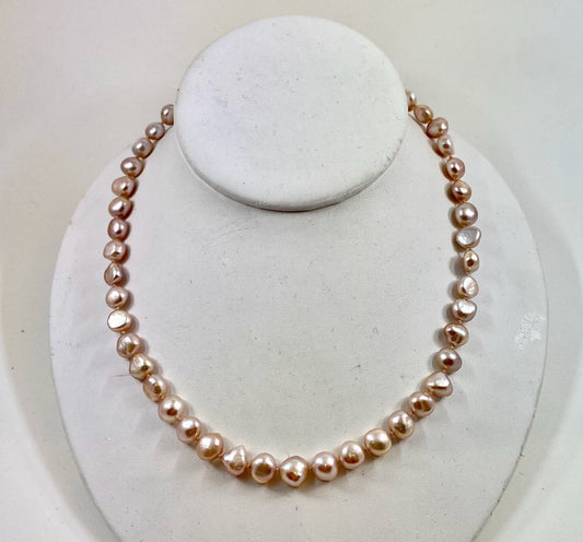 Pearls. Beautiful strand of knotted pale pink fresh water pearl necklace. The necklace is finished with a gold-filled  lobster clasp.