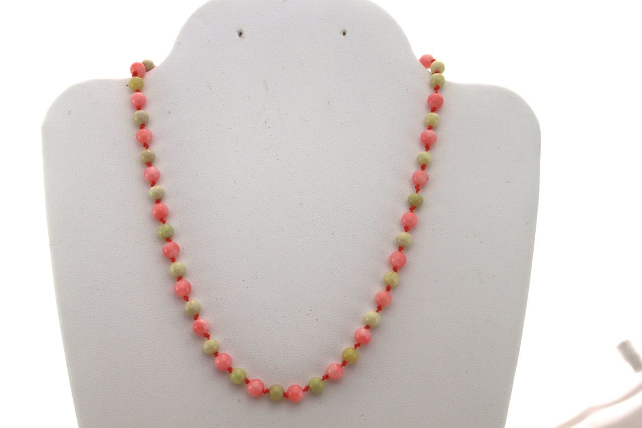 Finely knotted coral and jade necklace for babies and toddlers.