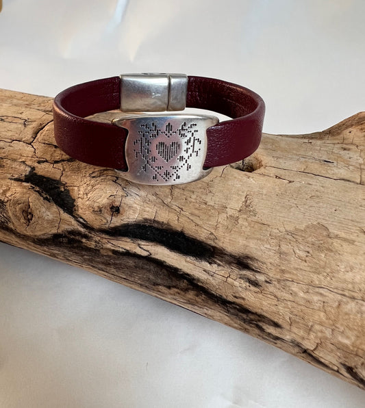 Italian rich deep red leather bracelet with heart etched silver accent piece. Closed with a silver magnetic clasp.