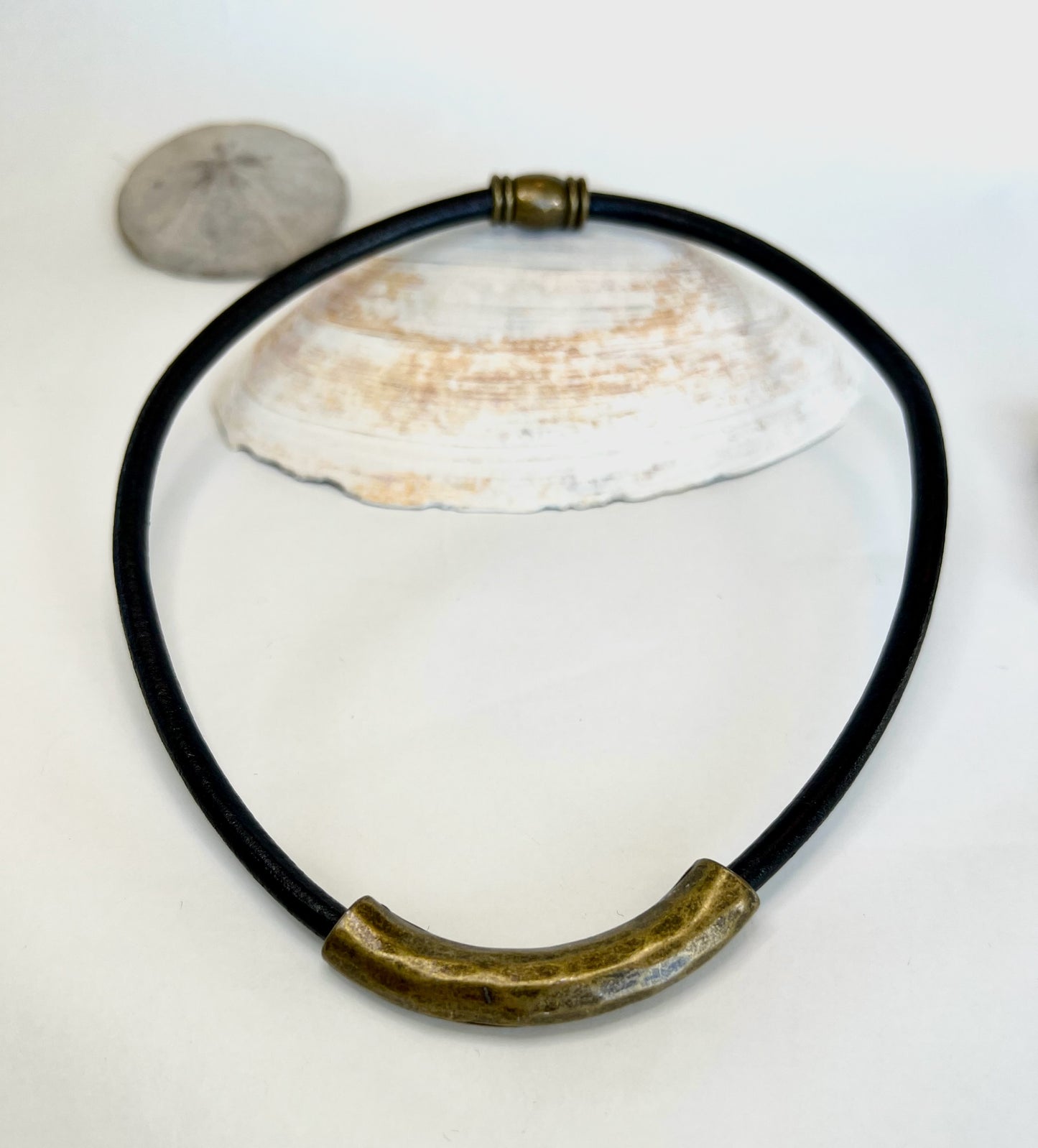 Leather Necklace. Beautiful Italian black leather choker necklace fashioned with a center curved brass tube. Finished with a magnetic clasp.