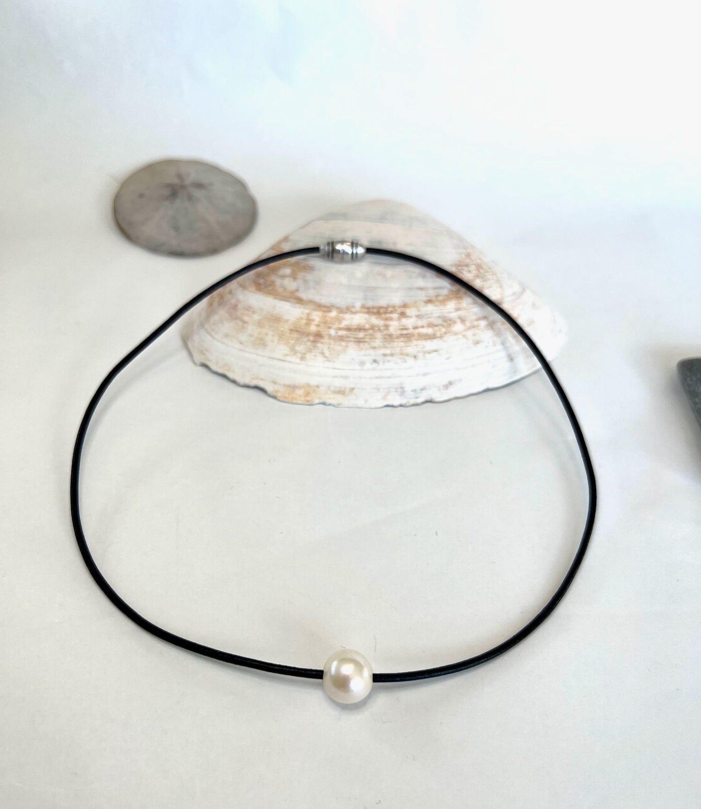 Leather Necklace. Elegant single smooth white pearl slides freely on this soft black Italian leather cord. Finished with a silver magnetic clasp.