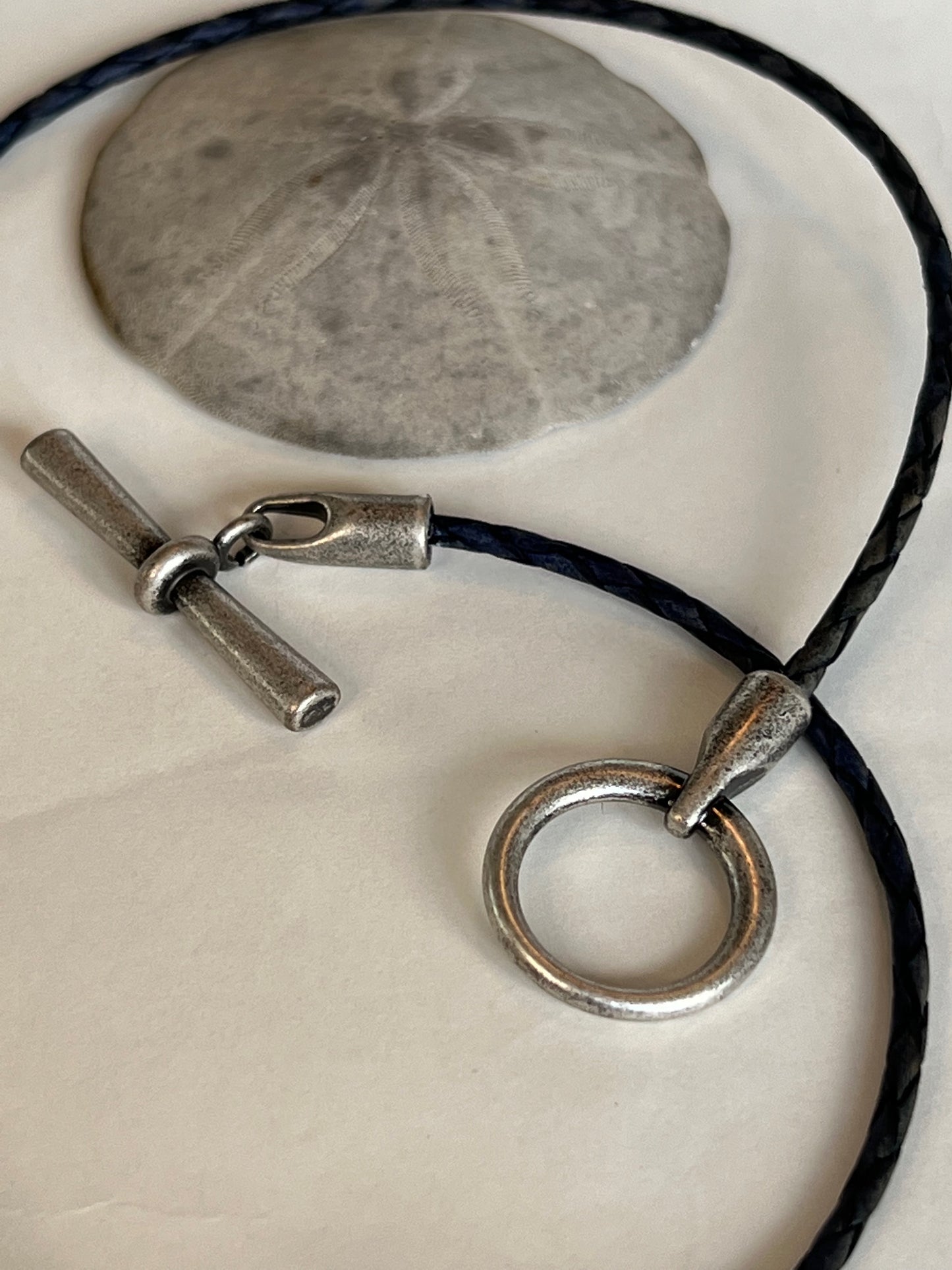 Leather Necklace  Sweet dark blue braided Italian leather necklace. Accented with a silver toggle clasp to be worn in the front as a focal piece.  16.5" long.