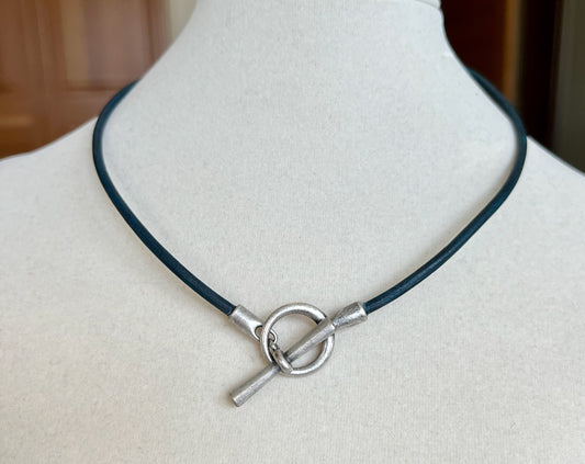 Leather Necklace  Beautiful dark blue Italian leather necklace. Fashioned with a silver toggle clasp to be worn in the front as a focal piece.  16.5" long.