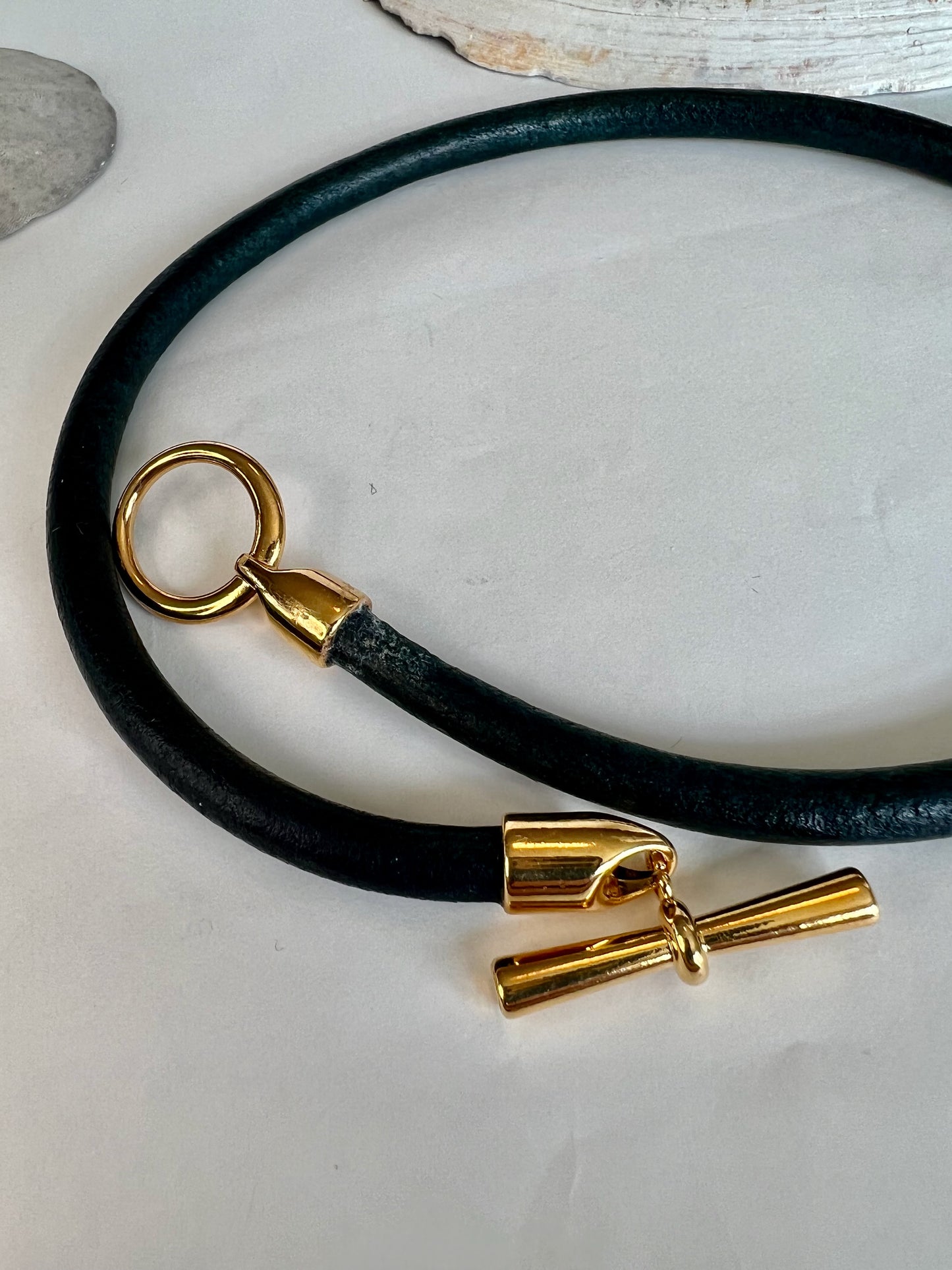 Leather Necklace  Dark distressed denim blue leather necklace with gold toggle clasp as center focus. 16" long.