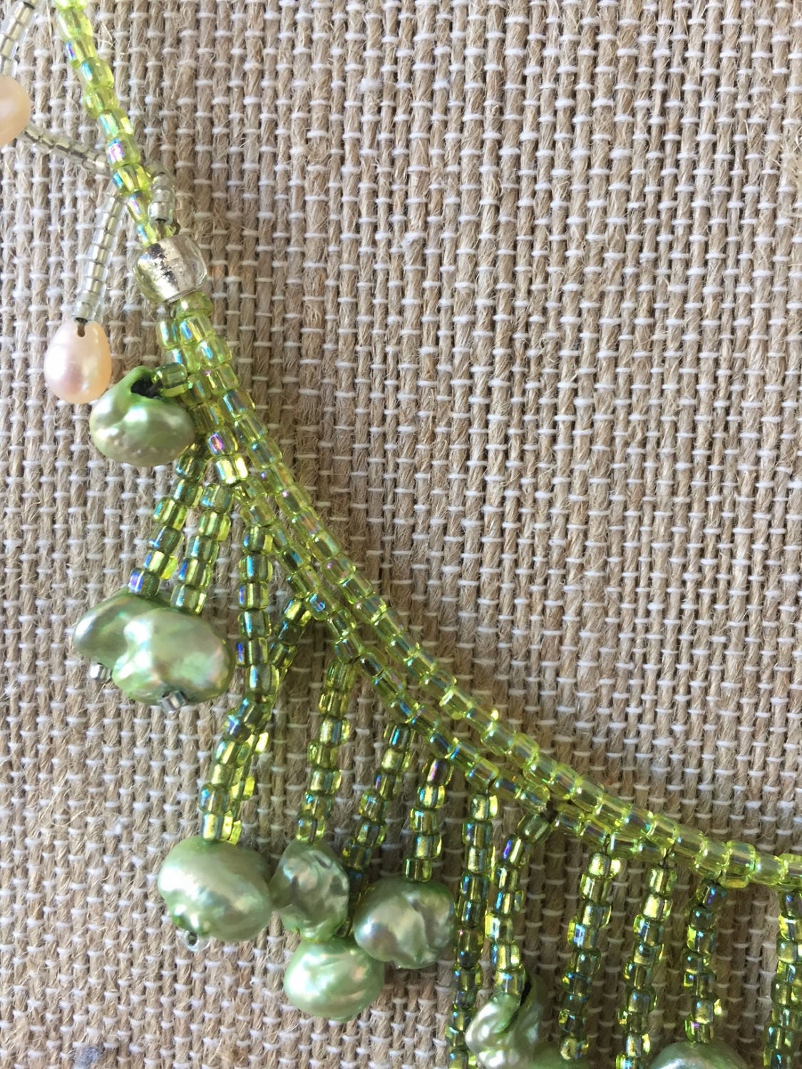 Hand woven pearl necklace. Beautiful flow with pearls and seed beads. Green and white pearls dangle on this necklace made by me in Maine.