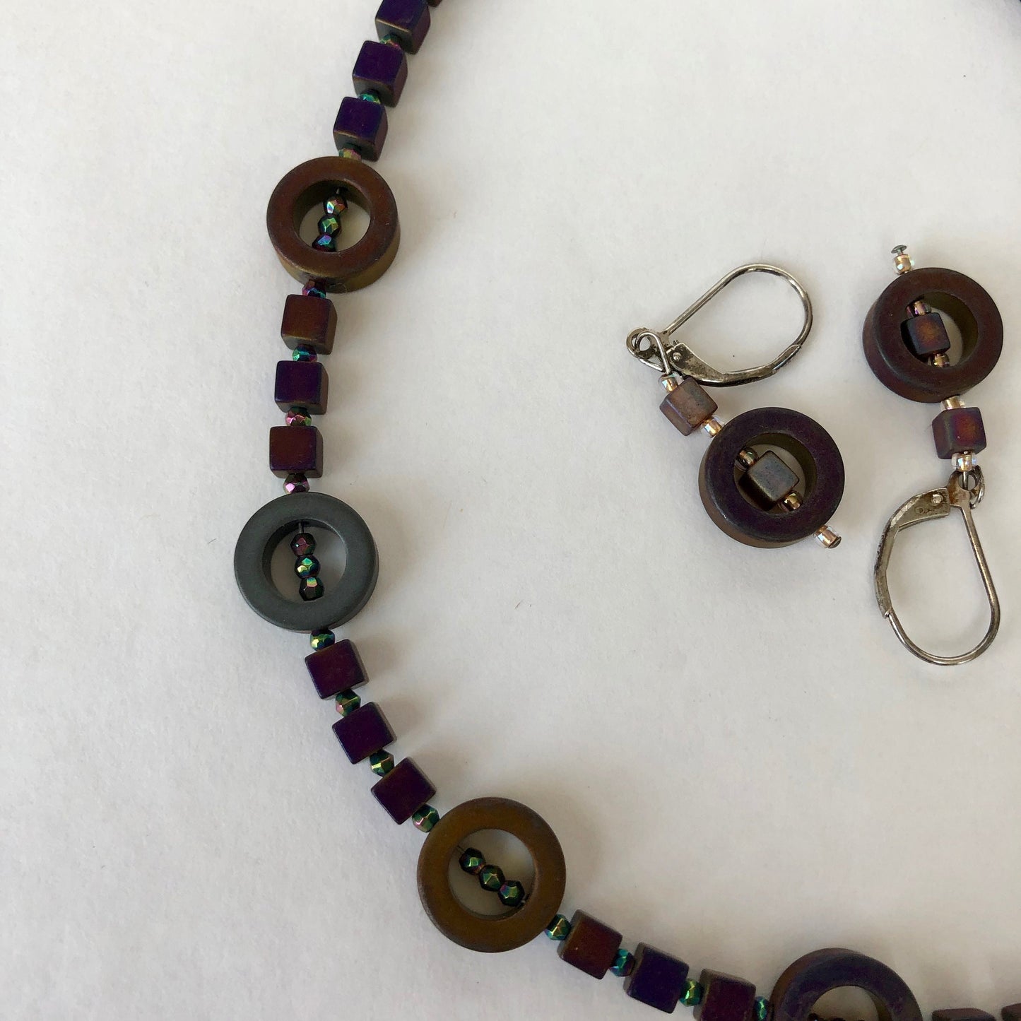 Striking and classy necklace, made of beautiful hematite stone beads. These dark purple stones, radiate with a slight aurora borealis tint.