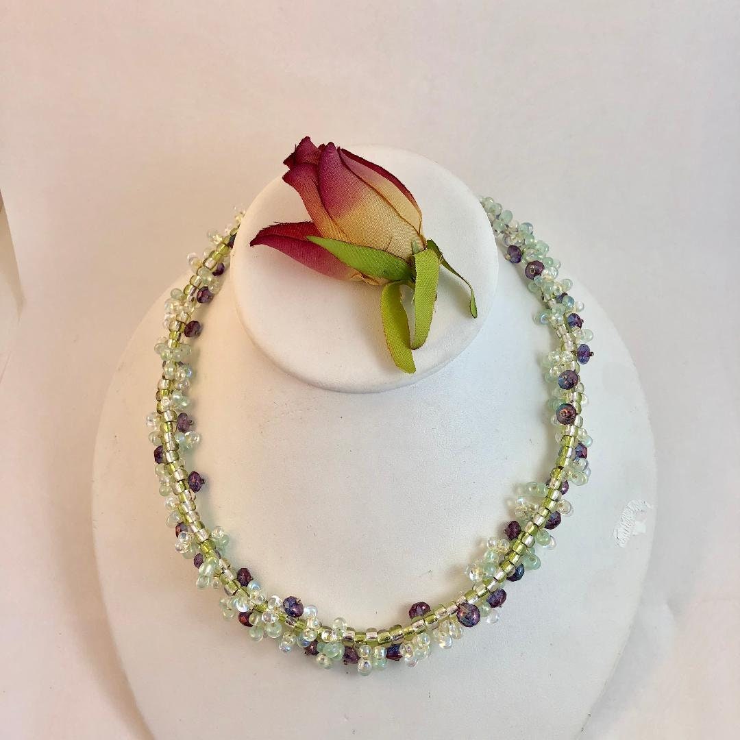 Stunning necklace hand beaded with aurora borealis tinted lime green and purple beads. A garden for your neck.
