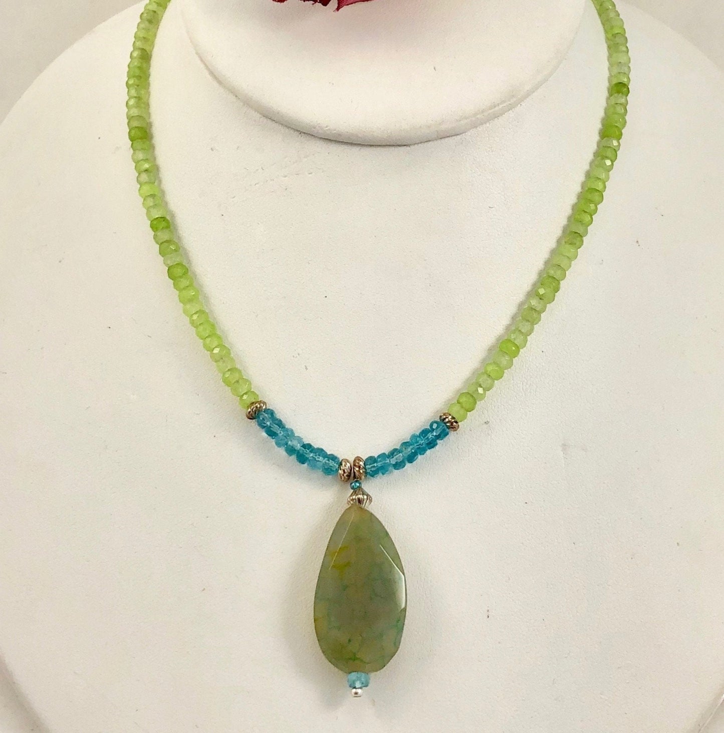 Stunning peridot beaded necklace accented with blue quartz beads and an agate drop.