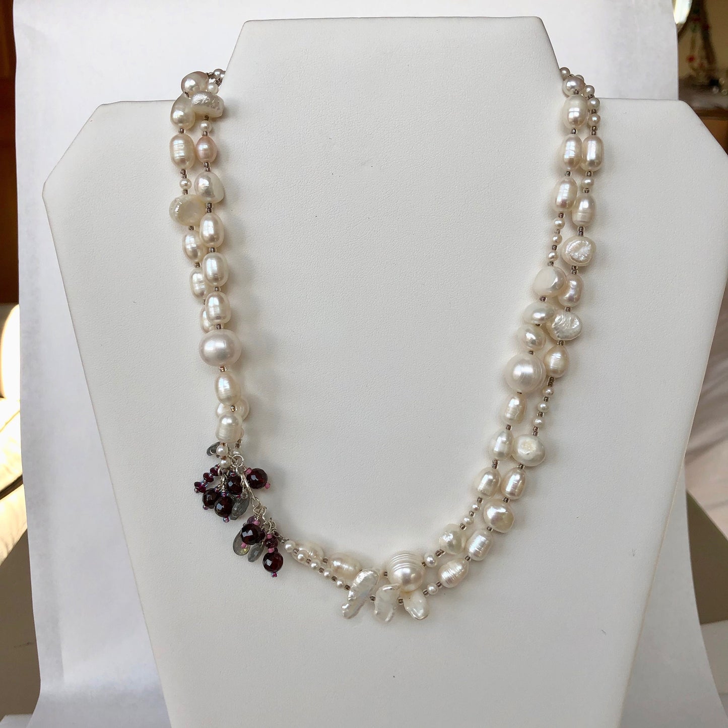 Pearls. Beautiful knotted fresh water pearl and garnet embellished necklace. The necklace is finished with a filigree gold clasp.