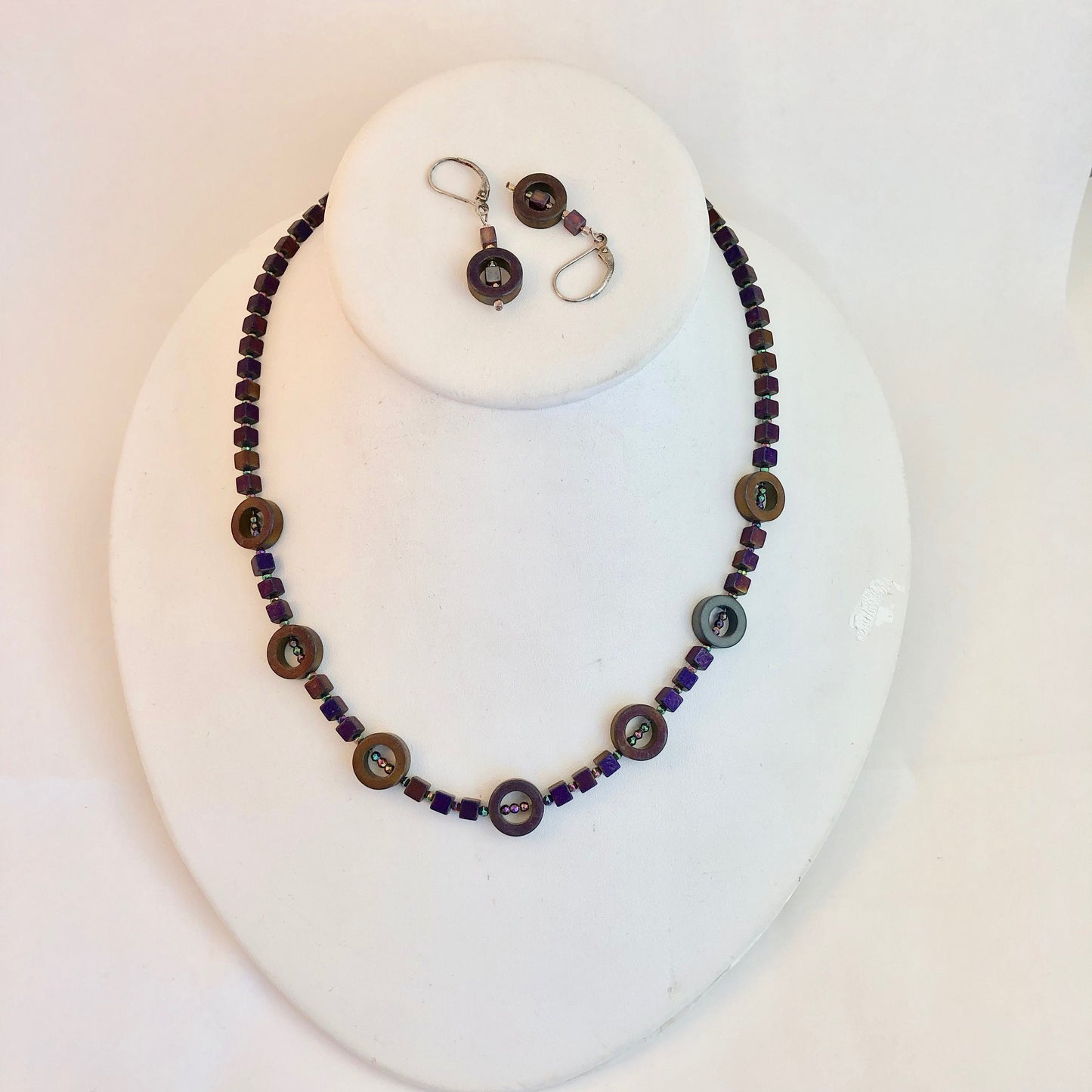 Striking and classy necklace, made of beautiful hematite stone beads. These dark purple stones, radiate with a slight aurora borealis tint.