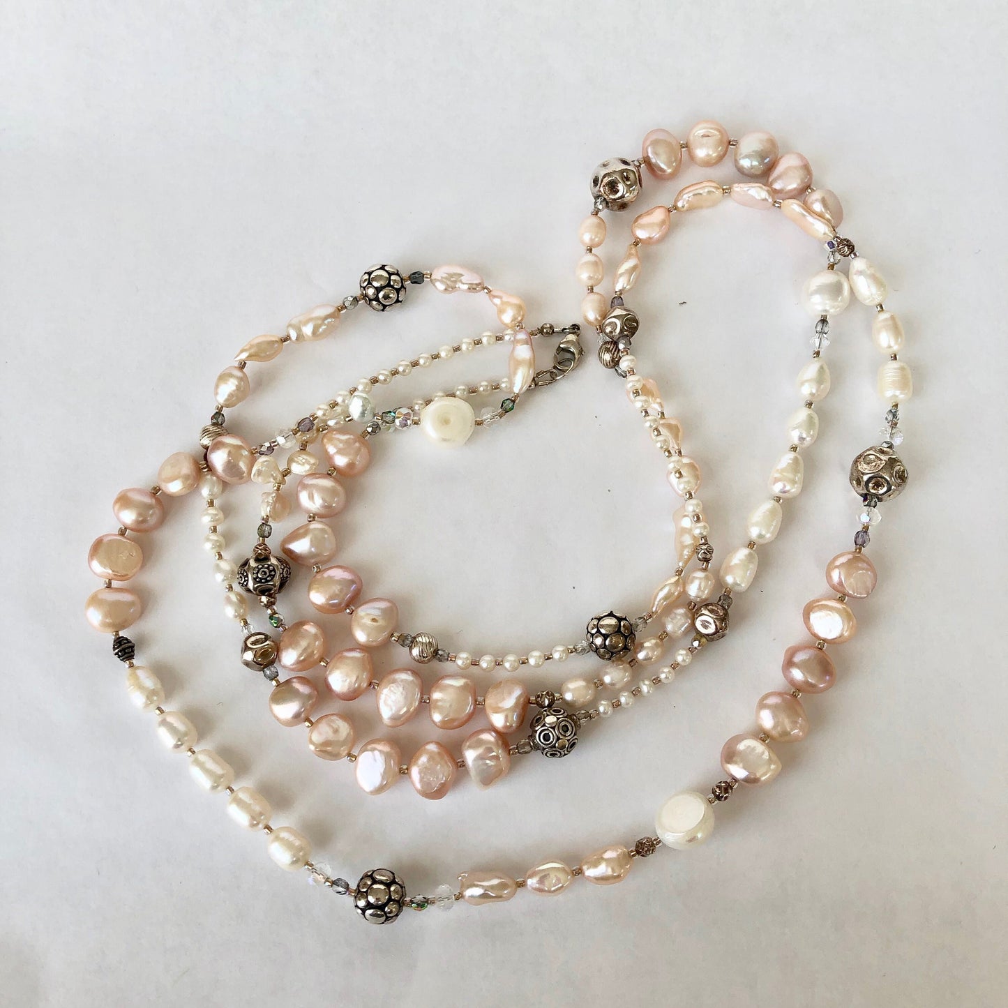 Necklace of stunning rows and rows of fresh water pearls. Pearls are accented by crystals and quality sterling silver beads.