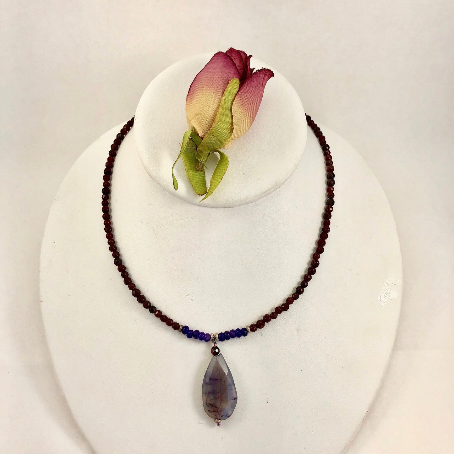 Stunning garnet, lapis and agate beaded necklace accented with  sterling silver swirl beads.