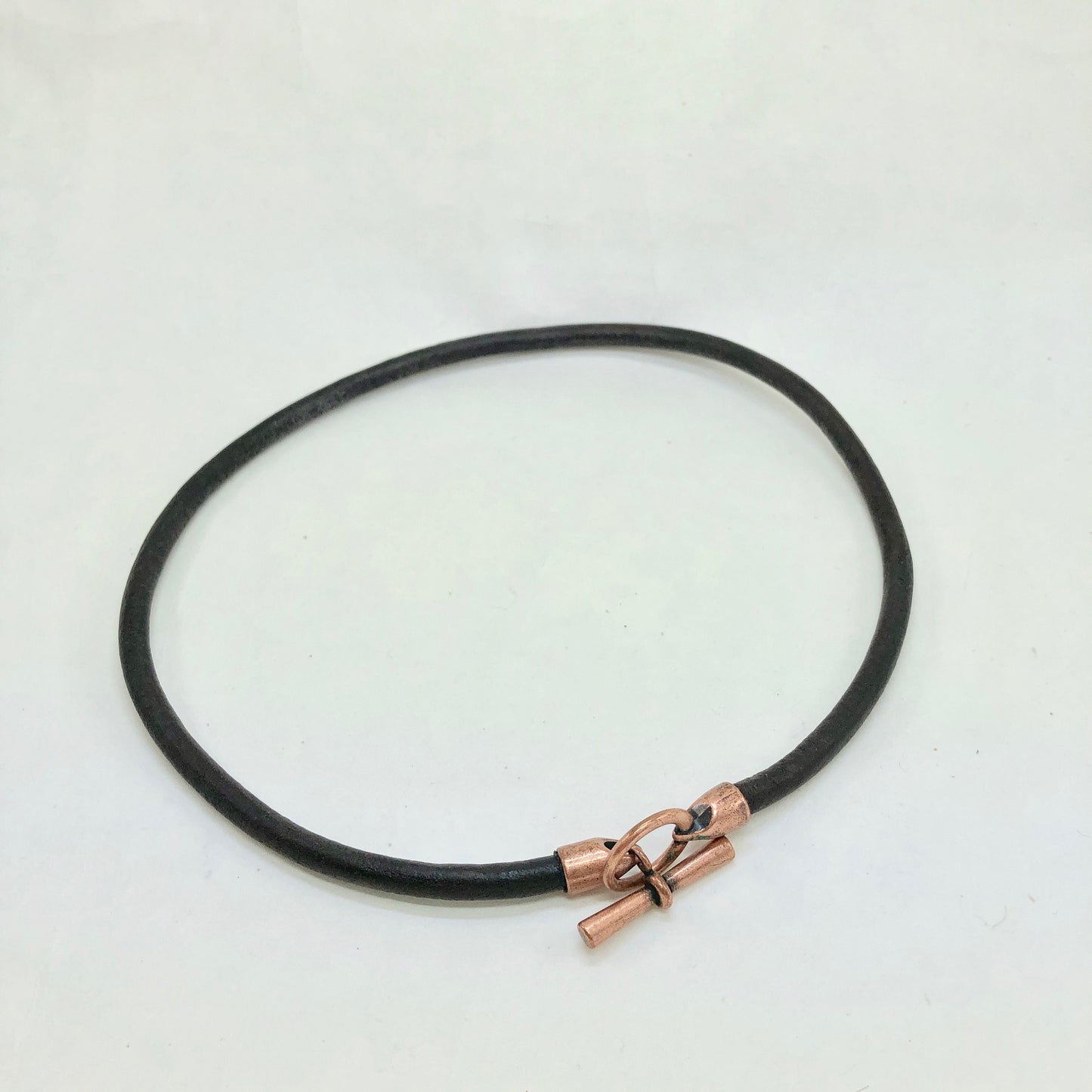 Leather Necklace. Striking Italian black leather choker necklace fashioned with a center copper toggle clasp.