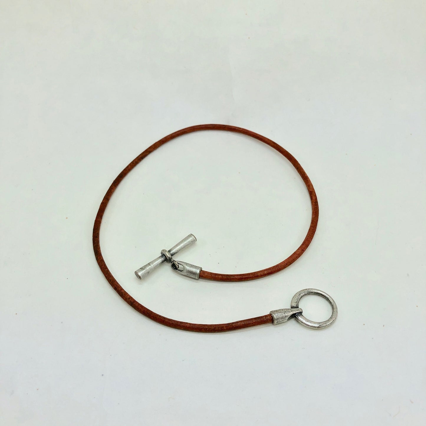 Leather Necklace. Hip brown Italian leather choker necklace fashioned with a center silver toggle clasp.