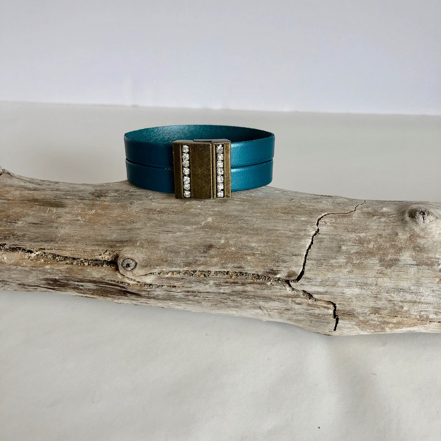 Leather bracelet, made with beautiful teal Italian leather, and finished with a quality bronze and crystal magnetic clasp. Double wrapped.