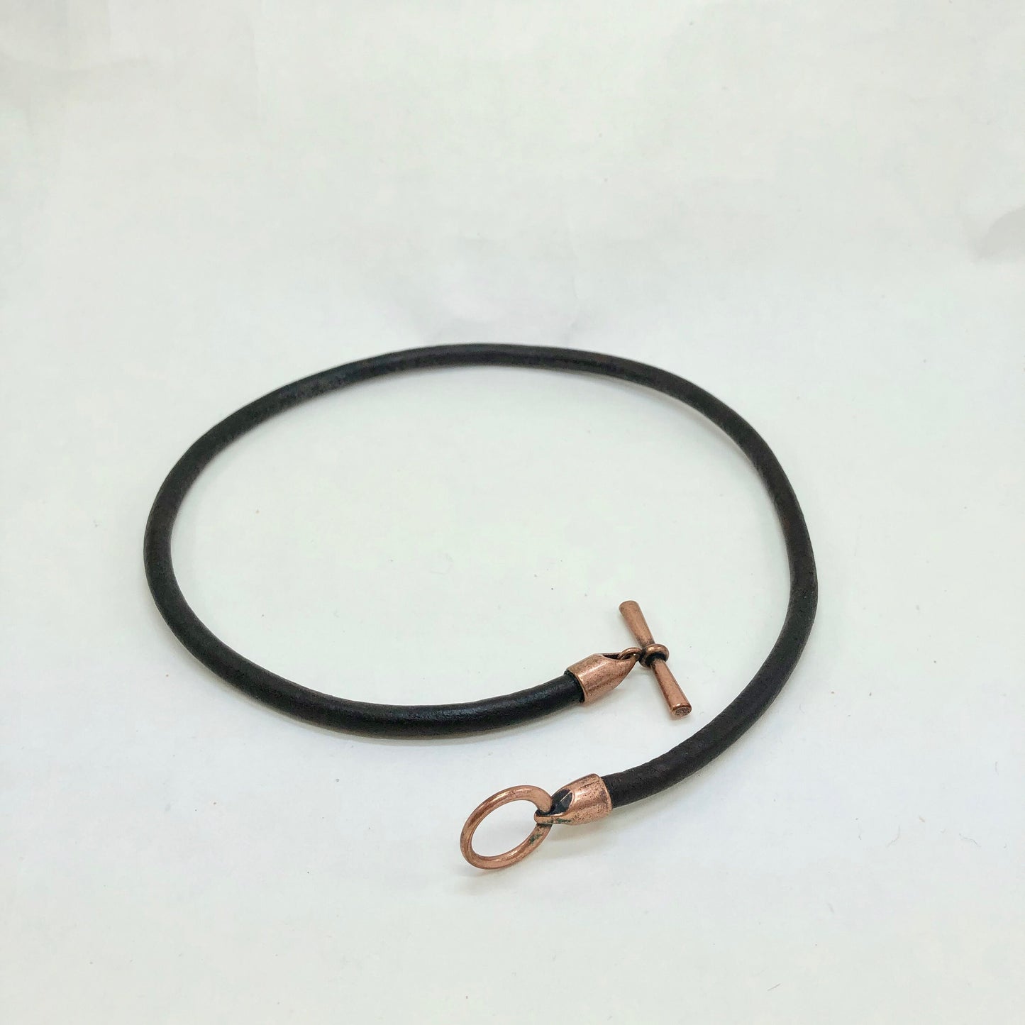 Leather Necklace. Striking Italian black leather choker necklace fashioned with a center copper toggle clasp.