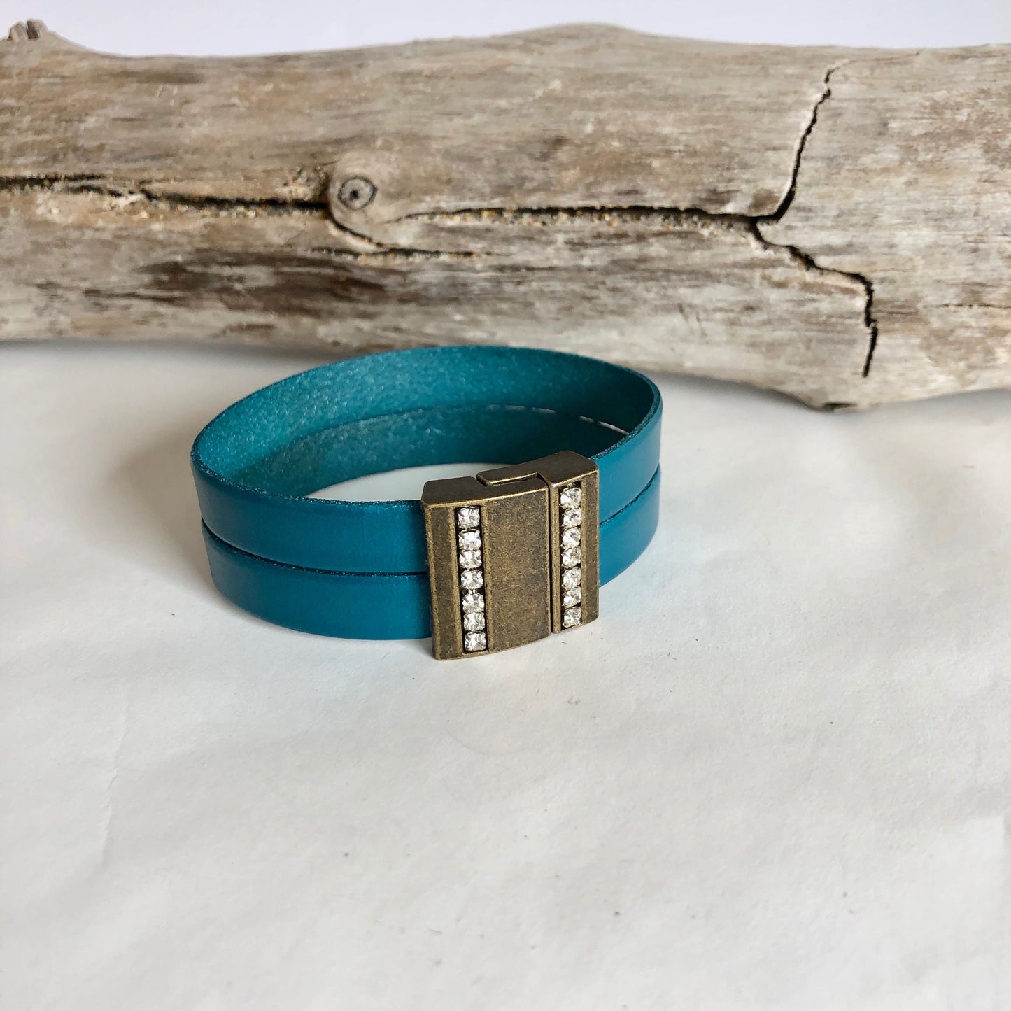 Leather bracelet, made with beautiful teal Italian leather, and finished with a quality bronze and crystal magnetic clasp. Double wrapped.