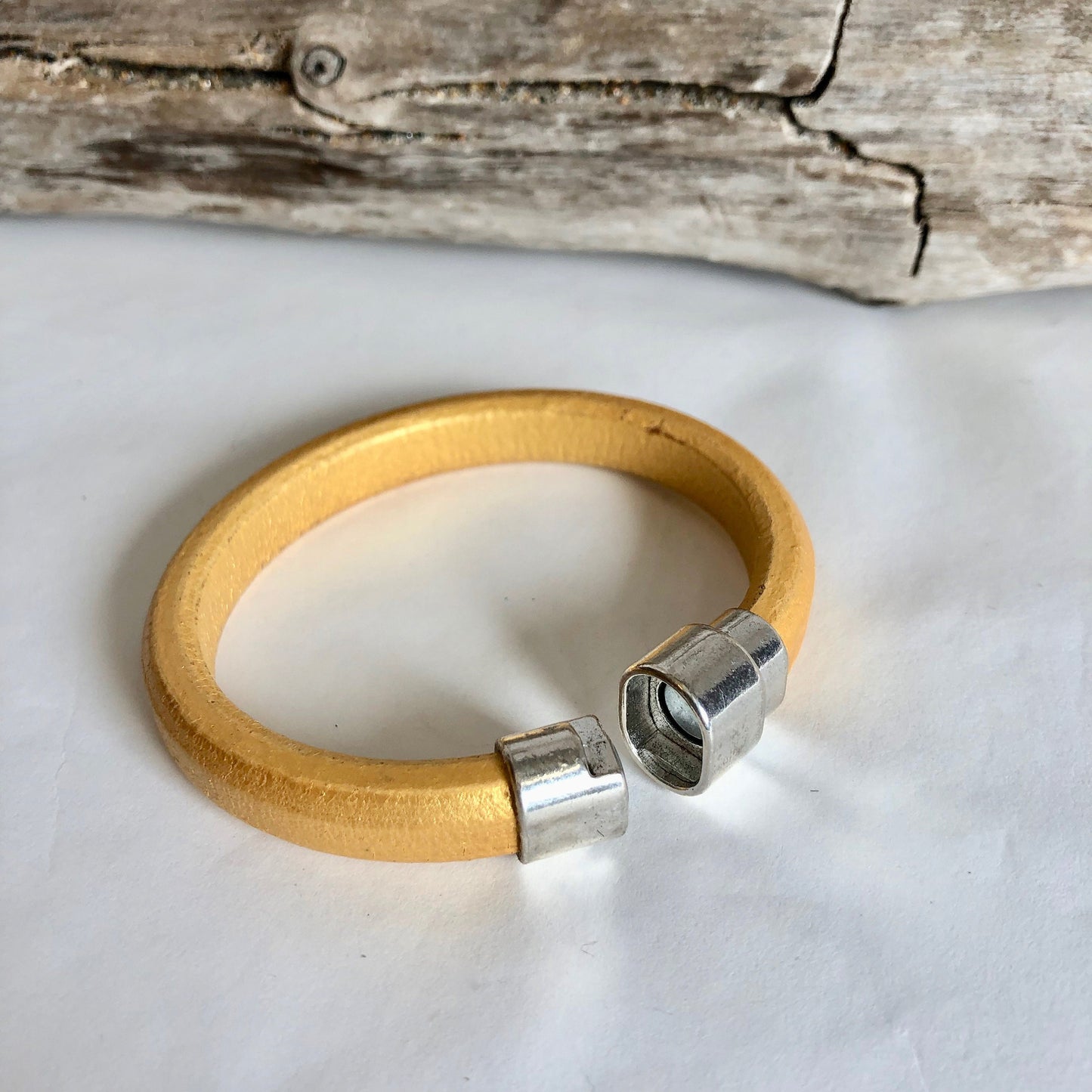 Leather bracelet, made of fine gold Italian licorice leather, finished with a quality silver magnetic bullet style clasp.