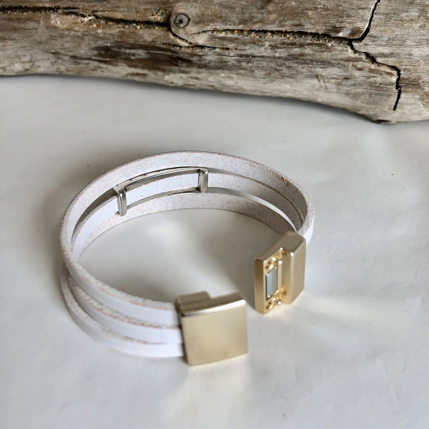Leather bracelet, made of fine white three wrapped Italian leather, a beautiful silver slide, and finished with a quality bronze magnetic clasp.