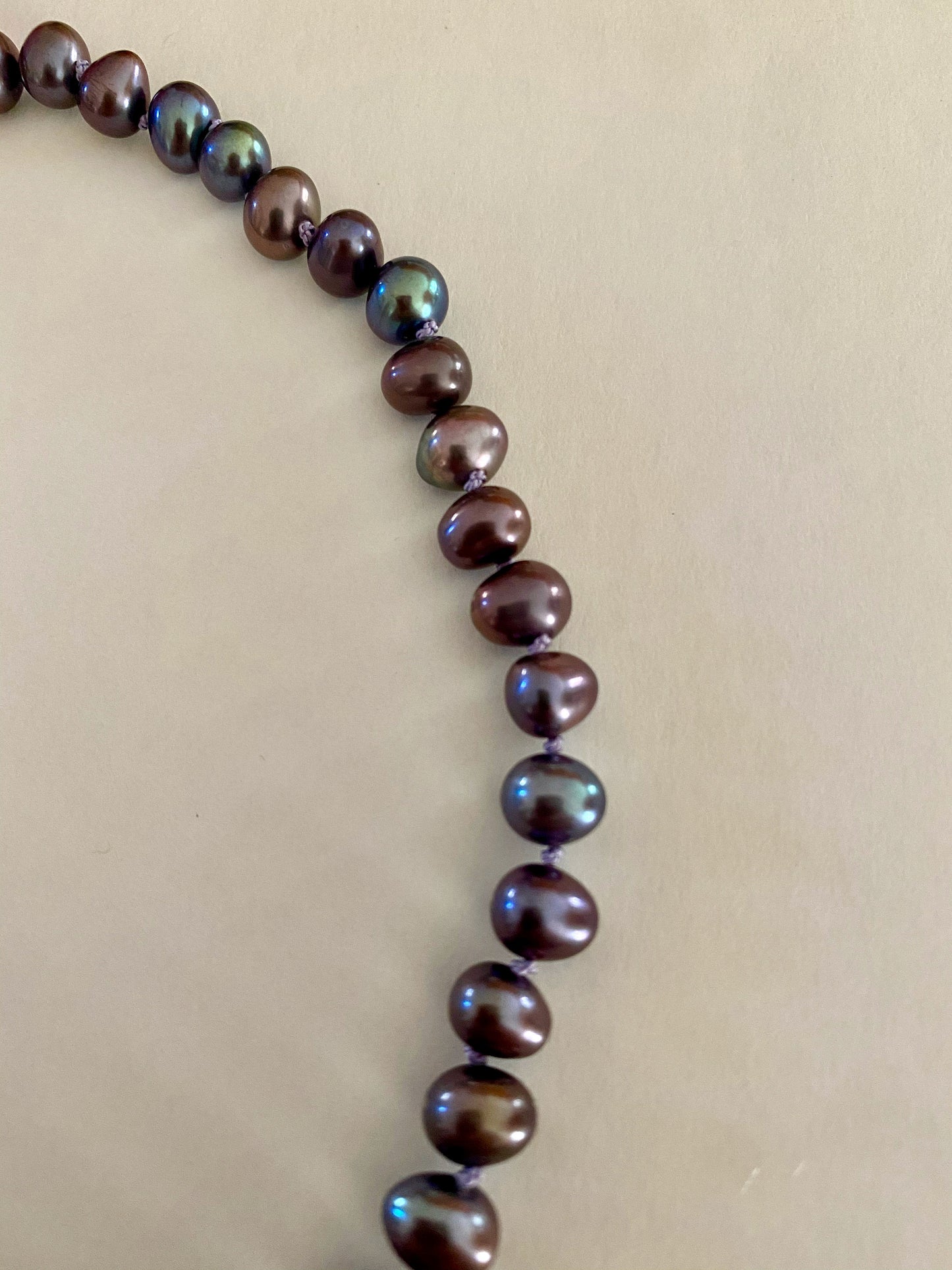 Pearls. Beautiful black/purple Aurora Borealis  knotted fresh water pearl necklace. The necklace is finished with a quality silver magnetic clasp.