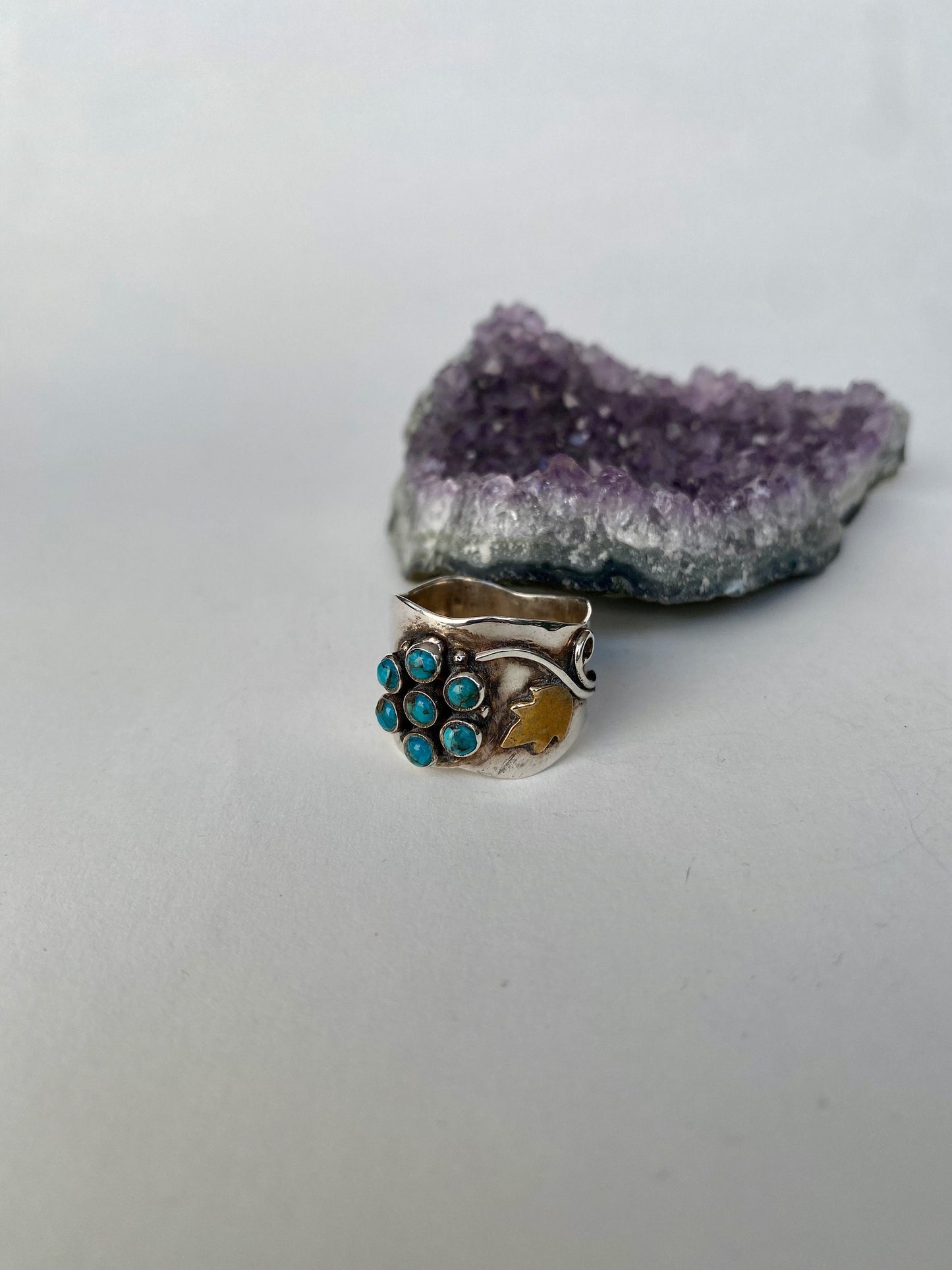 Handmade size 6 1/4 multi turquoise stone,  sterling silver band with gold accents.