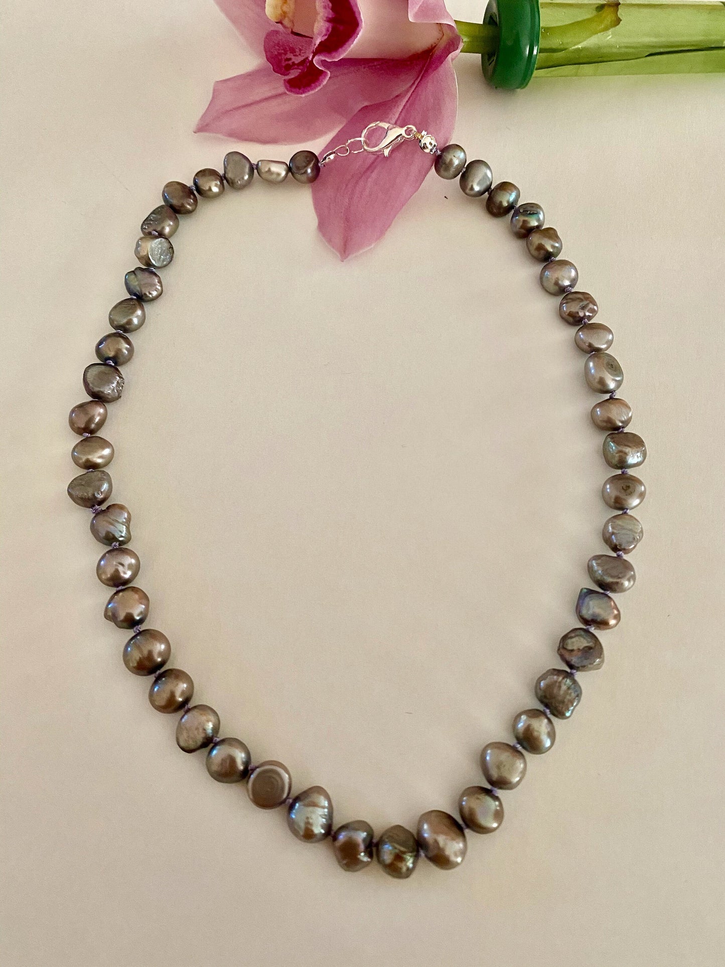Pearls. Beautiful black/purple Aurora Borealis  knotted fresh water pearl necklace. The necklace is finished with a quality silver magnetic clasp.