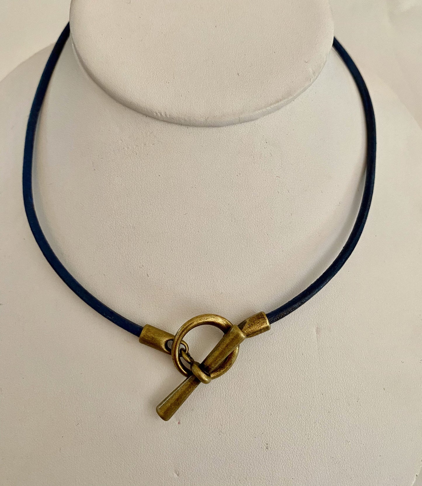 Leather Necklace. Hip Italian navy blue leather choker necklace fashioned with a center brass toggle clasp.