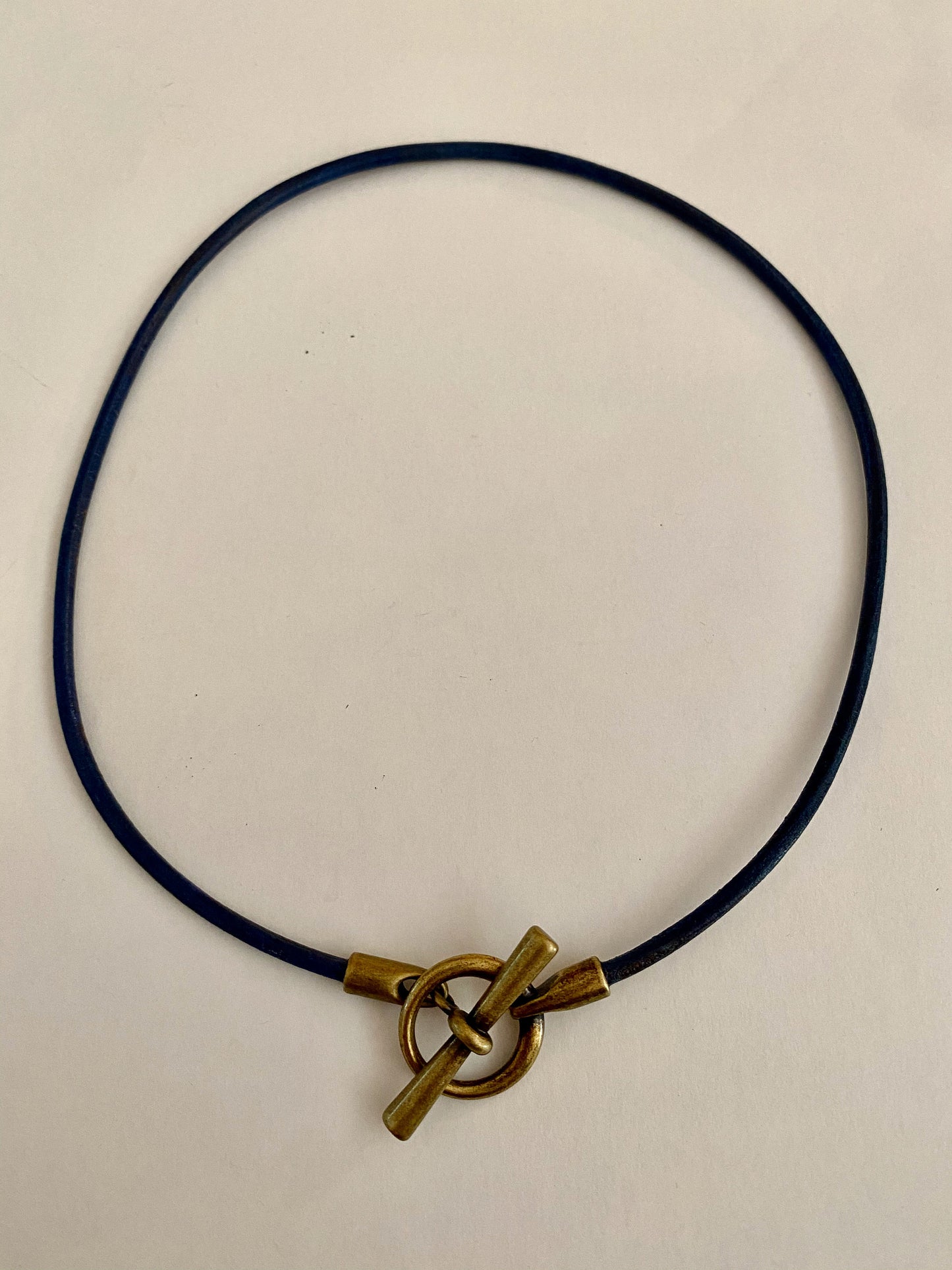 Leather Necklace. Hip Italian navy blue leather choker necklace fashioned with a center brass toggle clasp.