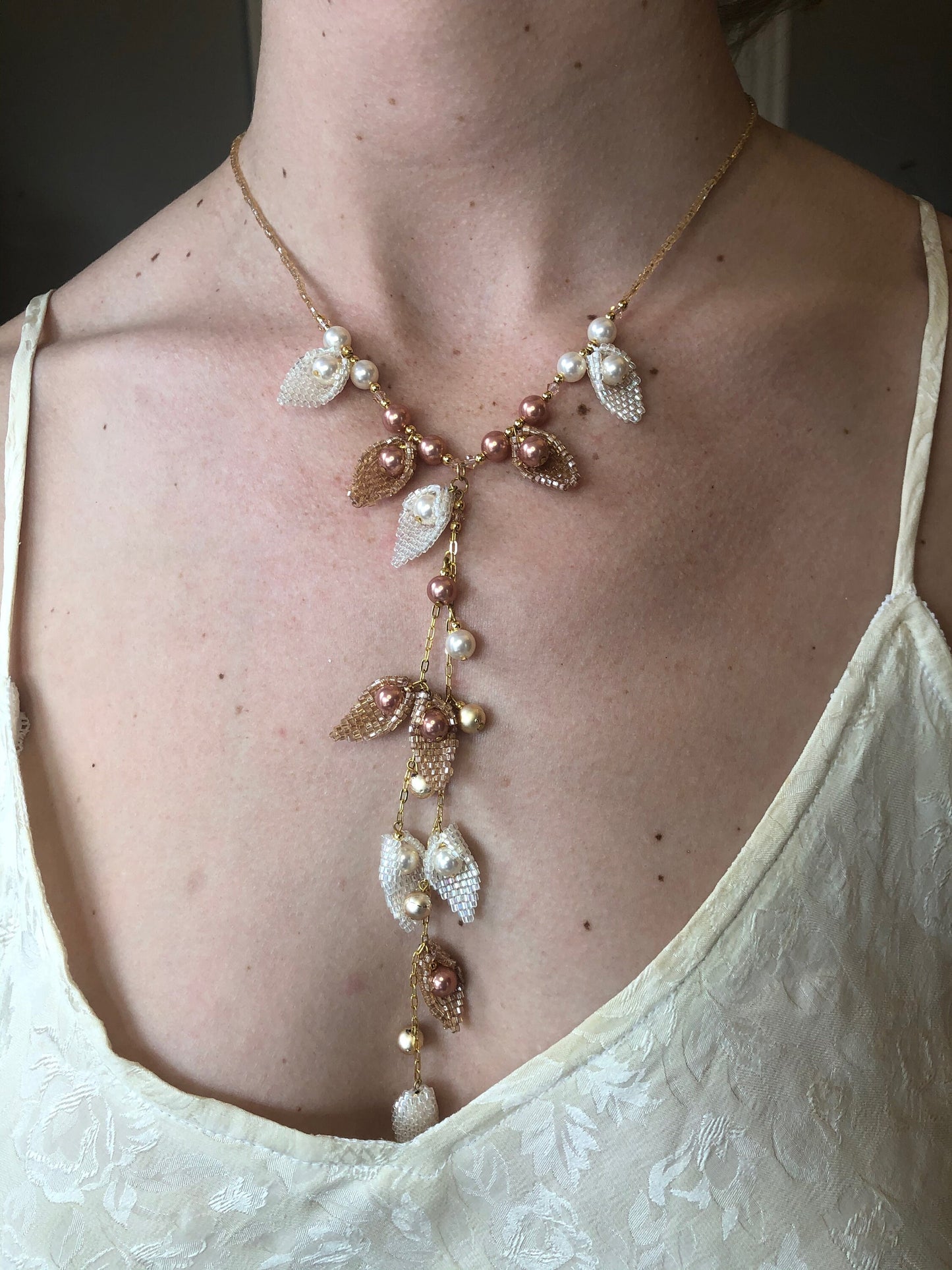 Necklace, handmade, handwoven leaves with set-in pearls makes for a flowing garden necklace.