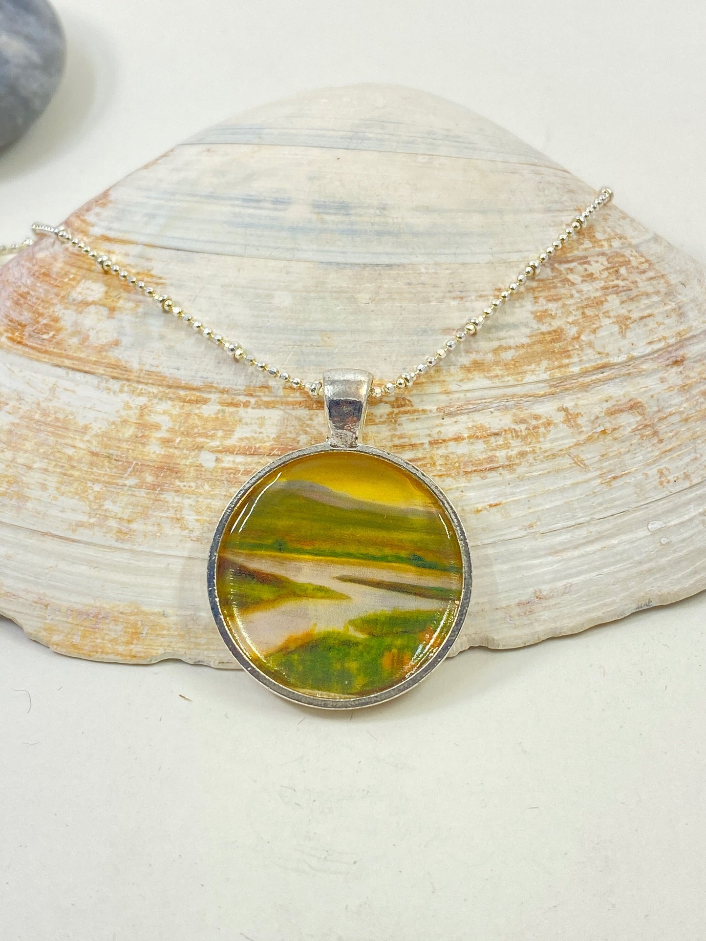 Original and beautiful Maine river scene hand painted pendant. Set in a silver bezel on a sterling silver chain.