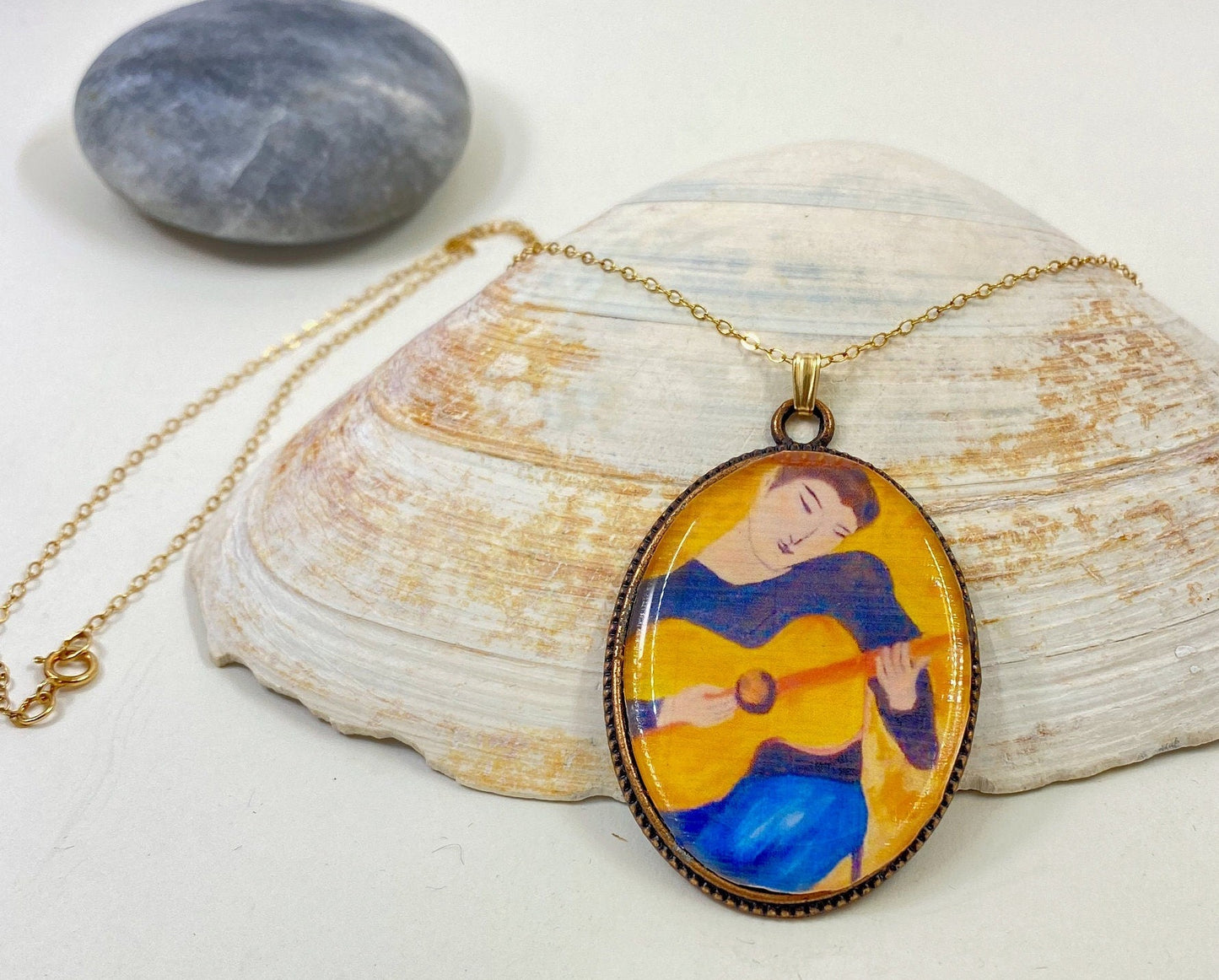 Original and beautiful hand painted guitar boy pendant. Brass frame and 14 karat gold filled chain.