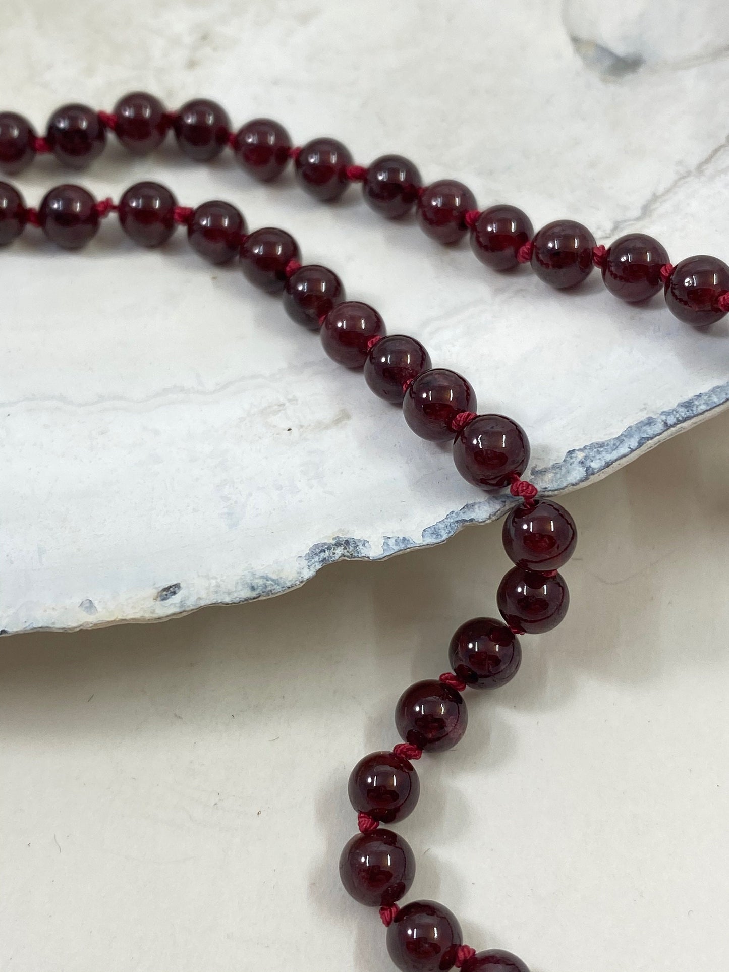 Exquisite garnet beaded and hand knotted necklace. Finished with a quality sterling silver lobster clasp.