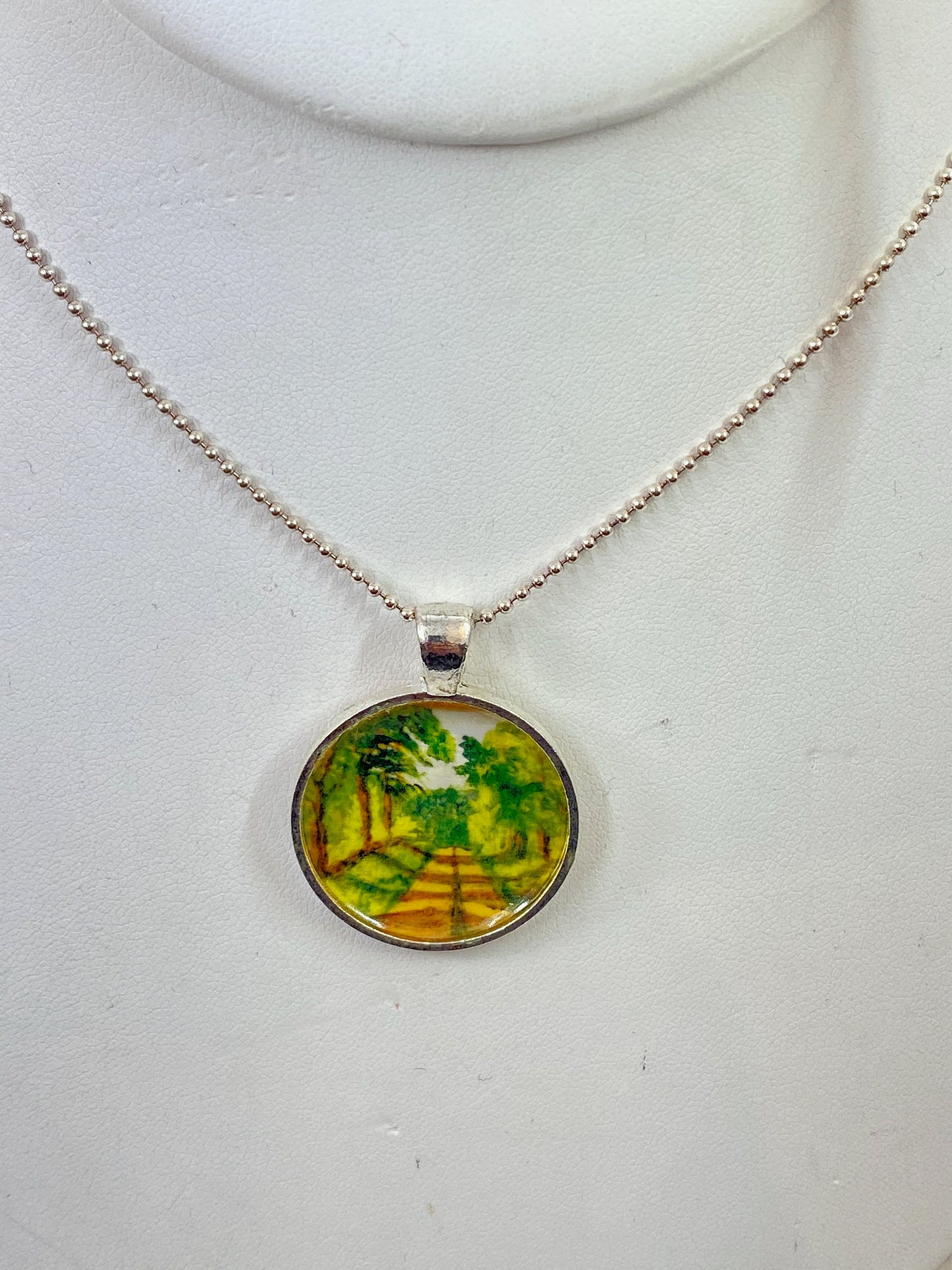 Maine country road scene hand painted pendant. Original print painted by me. Set in a silver bezel on a sterling silver chain.