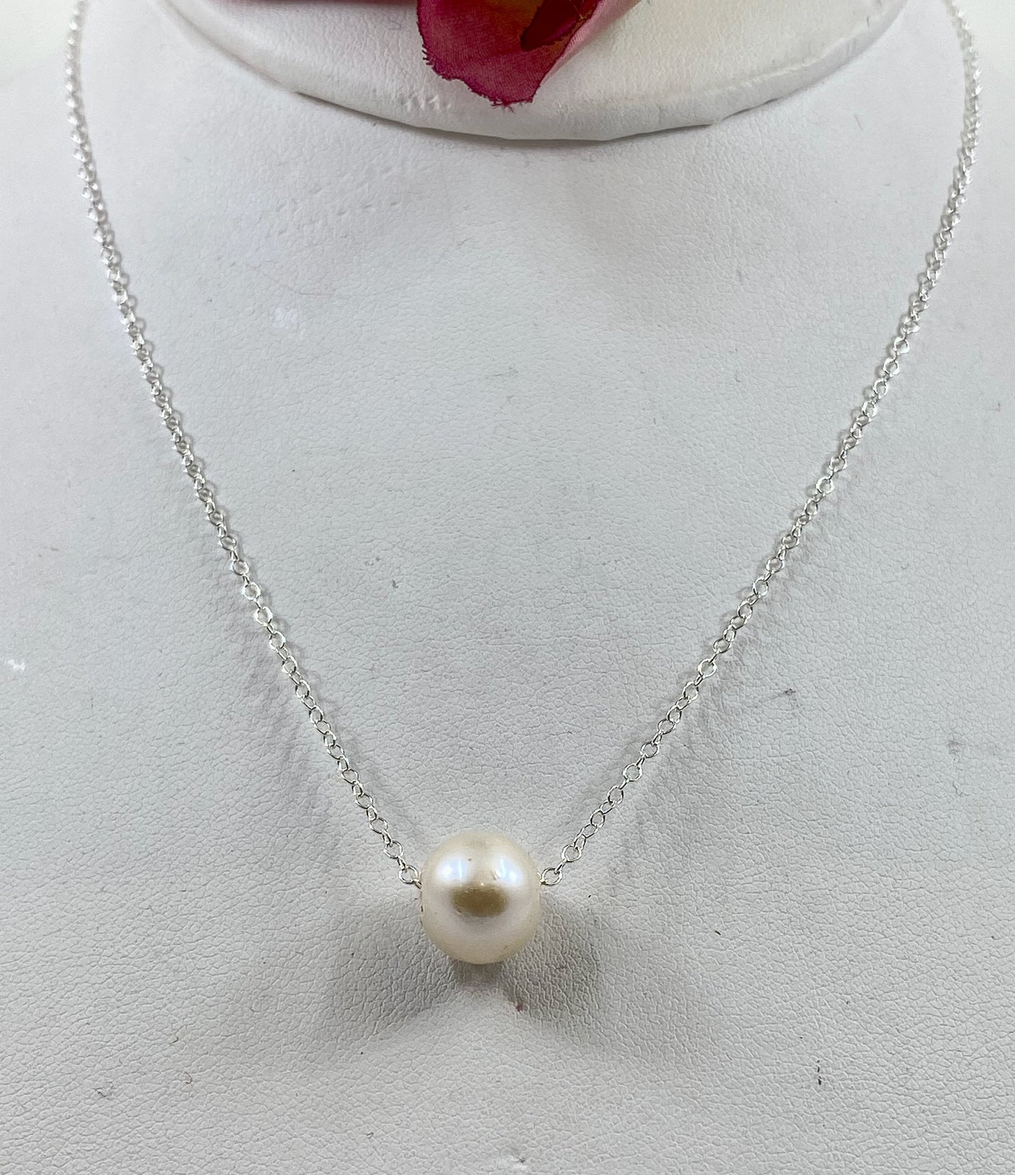Pearl necklace. This single smooth white pearl slides freely on this lovely quality sterling silver chain.