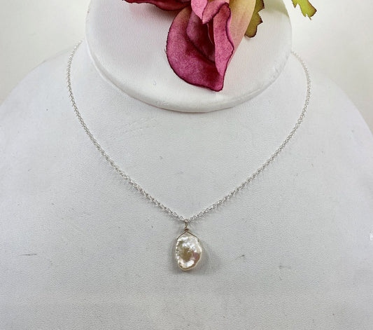 Fresh water pearl necklace. This single petal shaped white pearl slides freely on this lovely quality sterling silver chain.