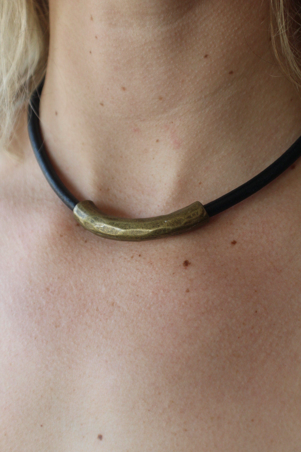 Leather Necklace. Beautiful Italian black leather choker necklace fashioned with a center curved brass tube. Finished with a magnetic clasp.