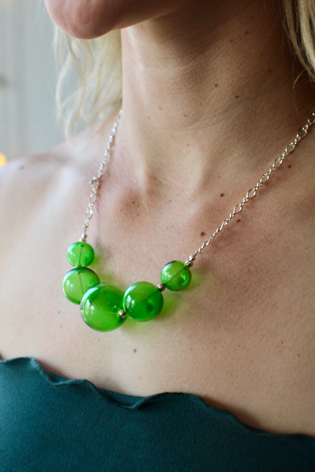 Stunning Italian green blown glass necklace. Accented with sterling silver beads and strung on a quality sterling silver clasp.