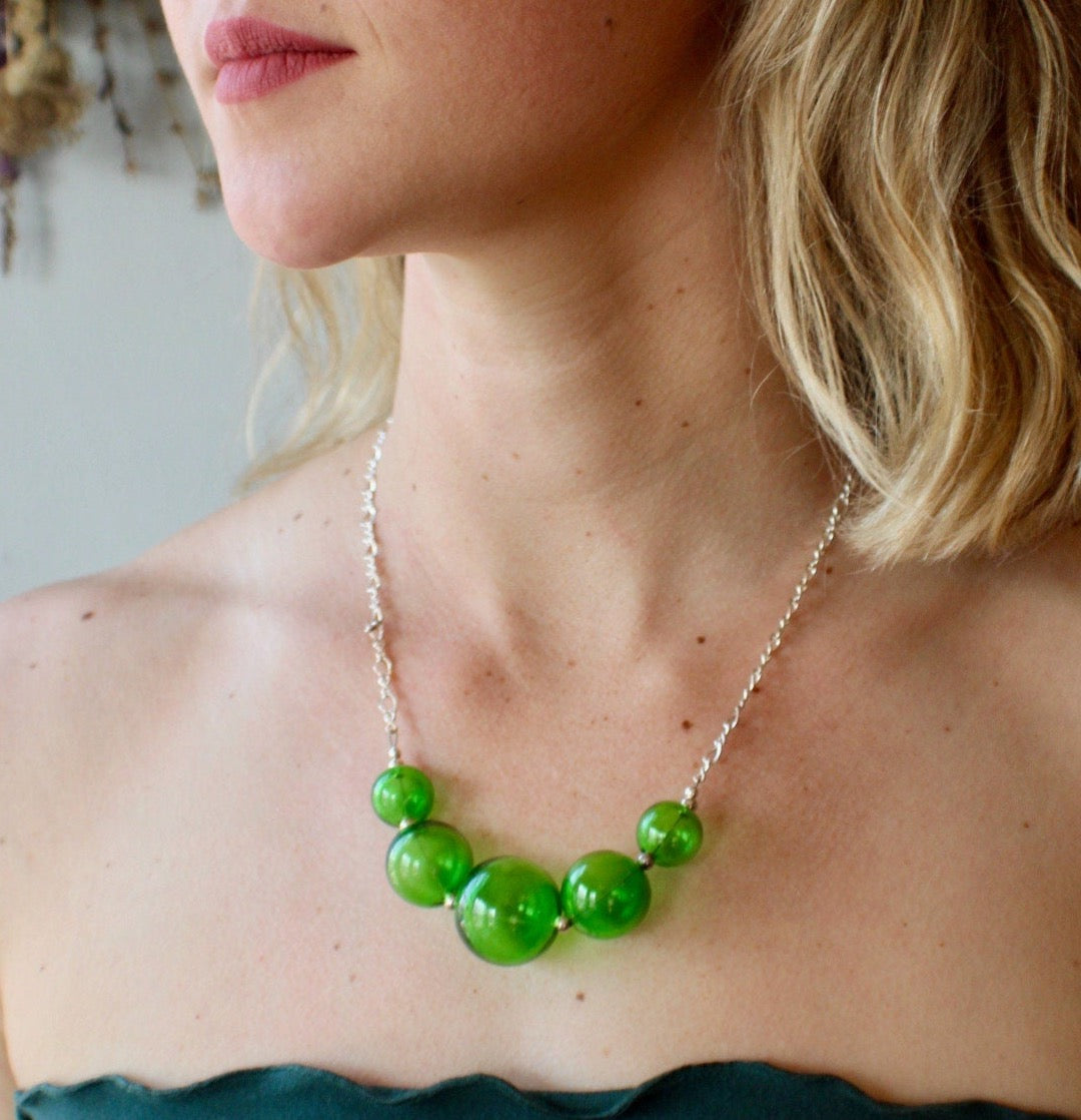 Stunning Italian green blown glass necklace. Accented with sterling silver beads and strung on a quality sterling silver clasp.