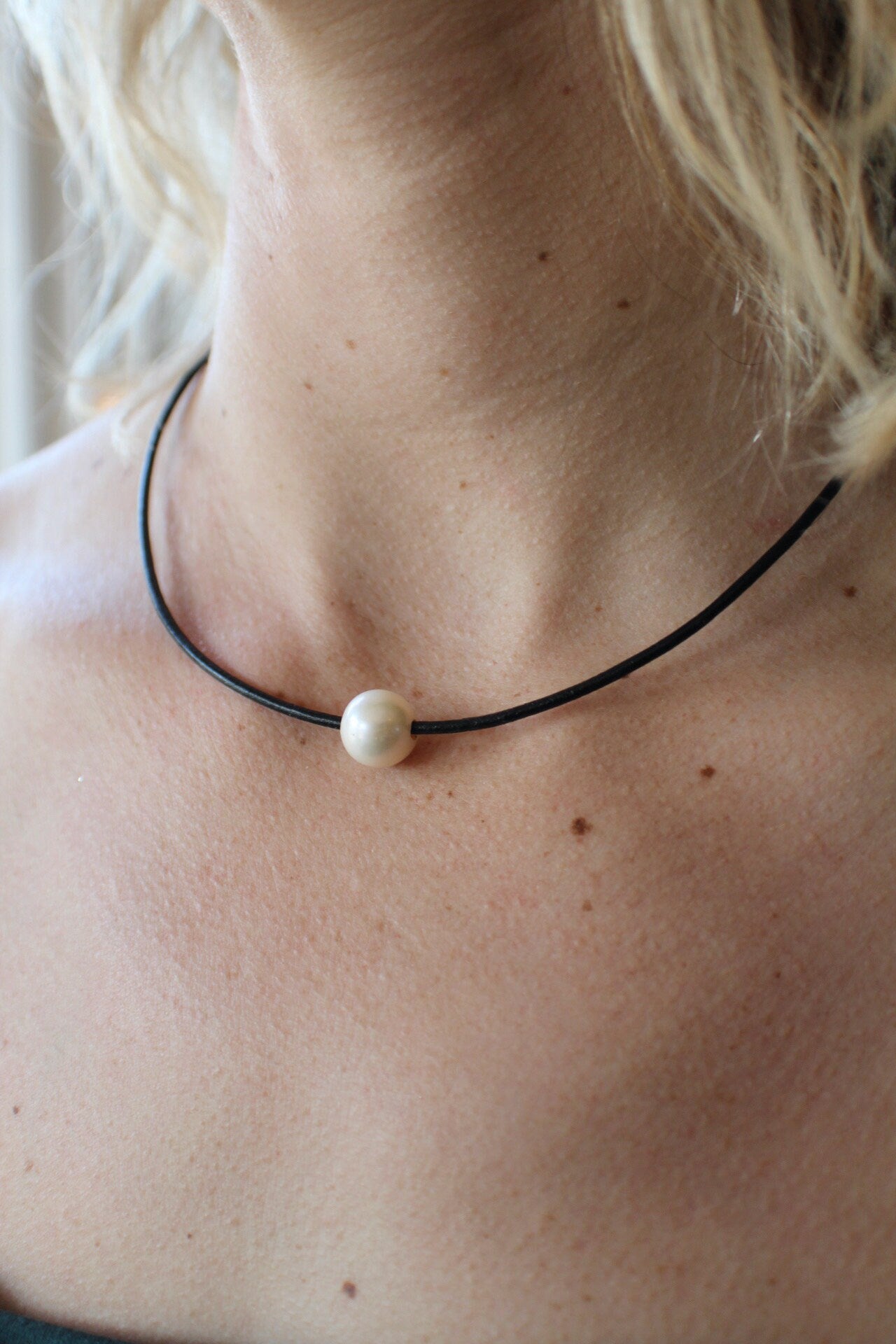 Leather Necklace. Elegant single smooth white pearl slides freely on this soft black Italian leather cord. Finished with a silver magnetic clasp.