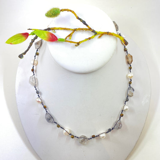 Pearls. Beautiful knotted quartz crystal and white fresh water pearl necklace. This necklace is hand knotted with black silk thread. Sterling clasp.