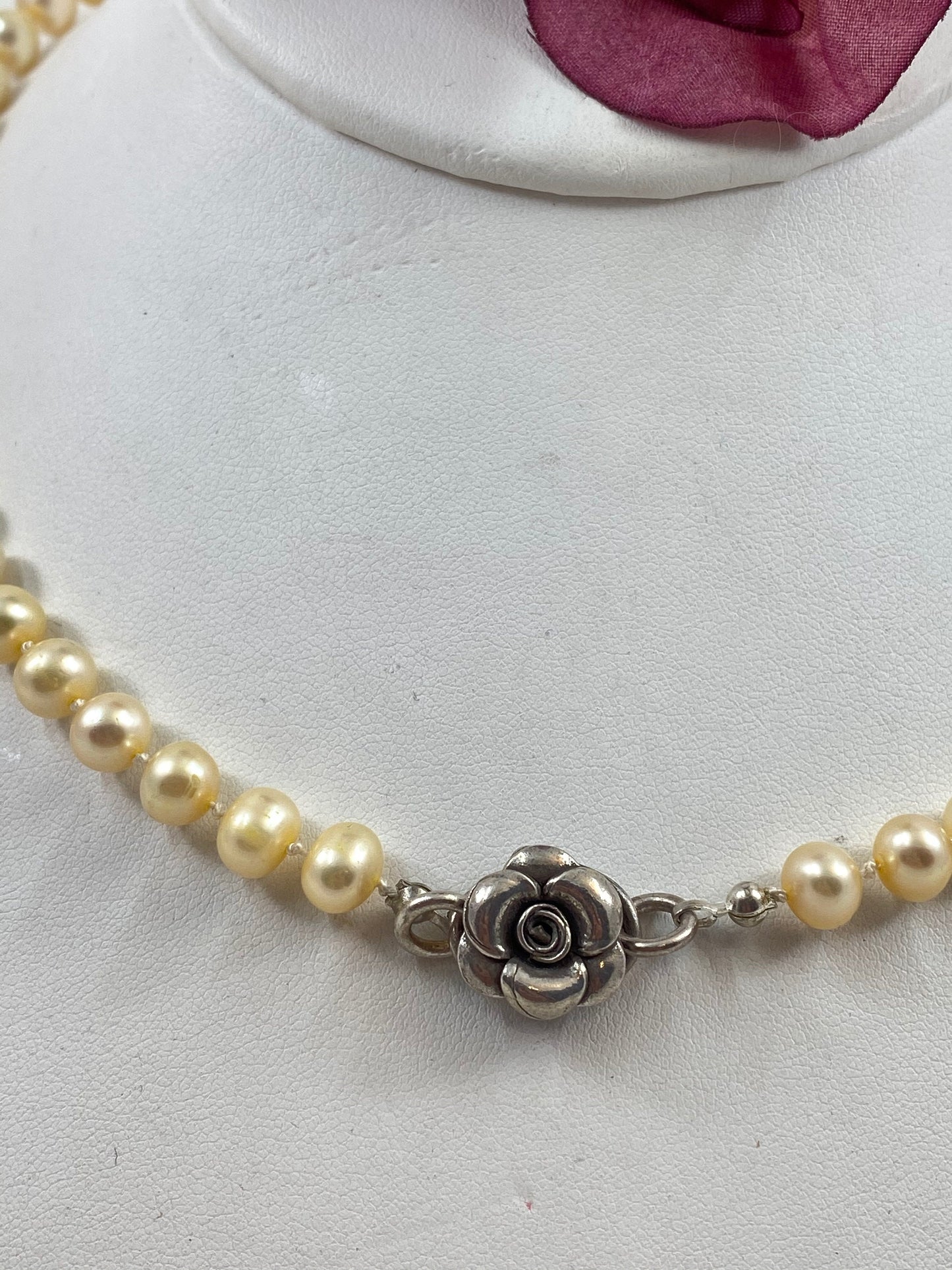 Gorgeous soft butter yellow knotted fresh water pearl necklace. The necklace is finished with a Thai sterling silver flower clasp.