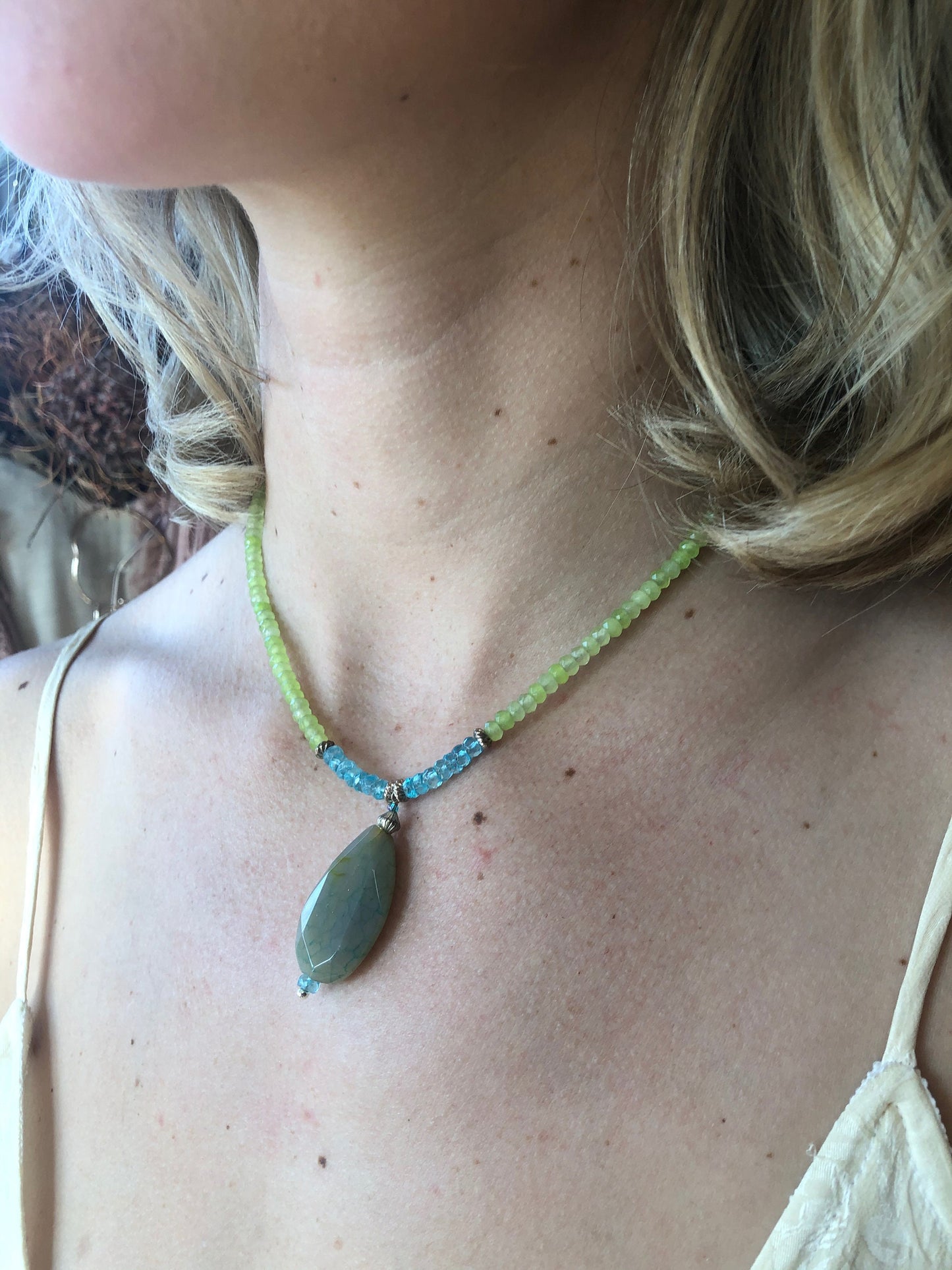 A lovely peridot beaded necklace, accented with tourmaline beads and an agate drop stone.