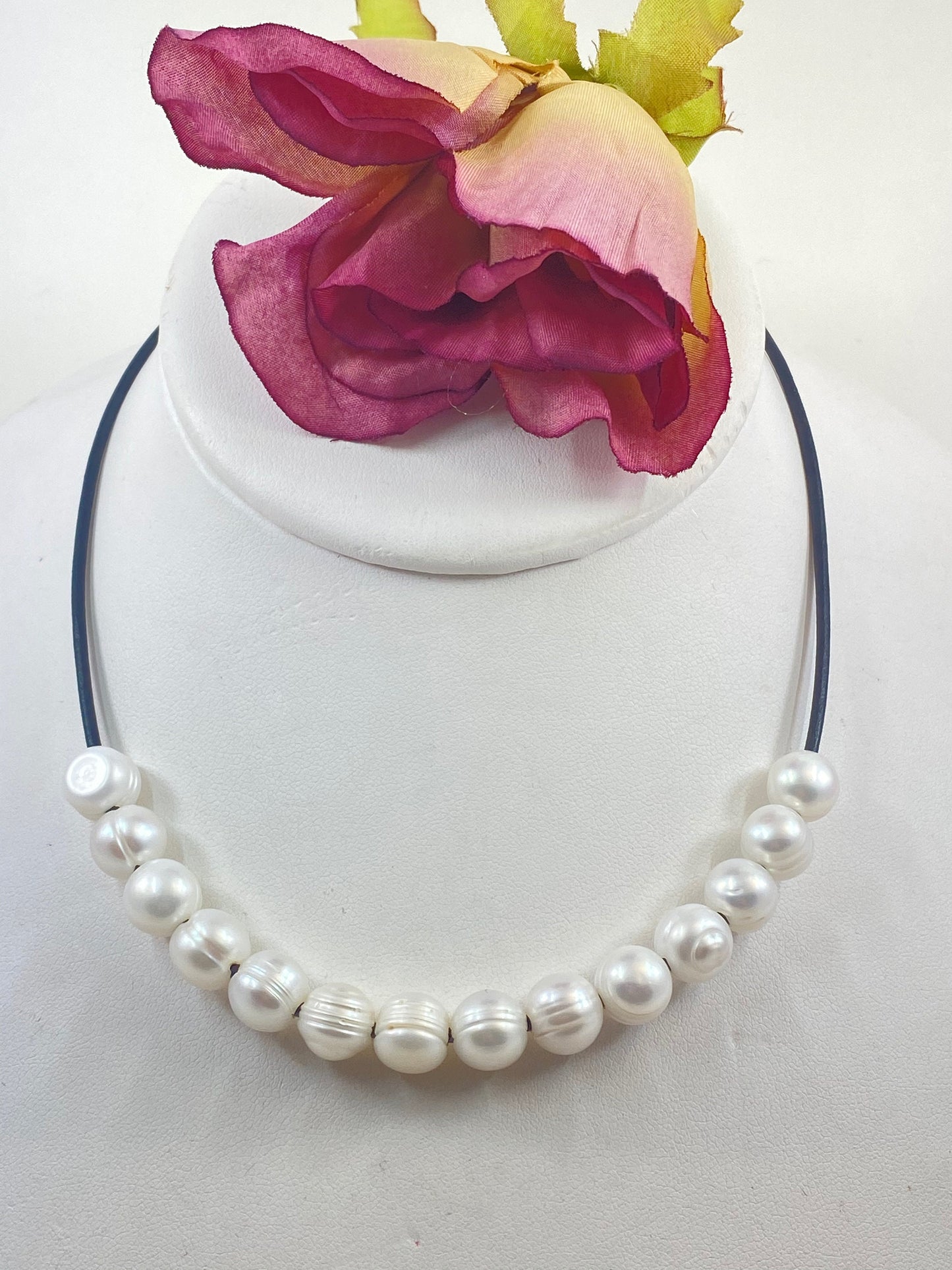 Leather Necklace. Elegant large white pearls slide freely on this soft black Italian leather cord. Thirty pearls. Finished with a silver magnetic clasp.