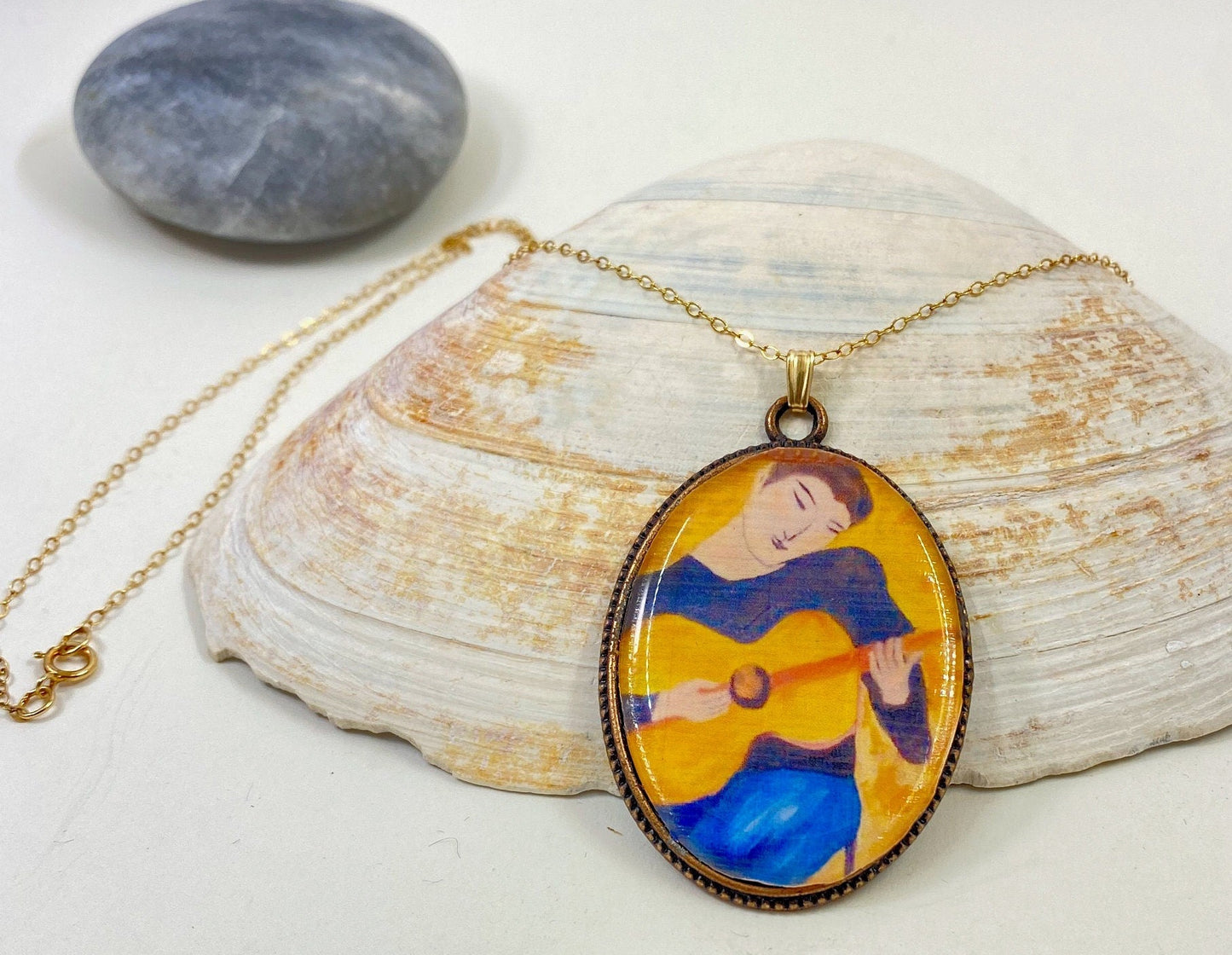 Original and beautiful hand painted guitar boy pendant. Set in a silver bezel on a sterling silver chain.